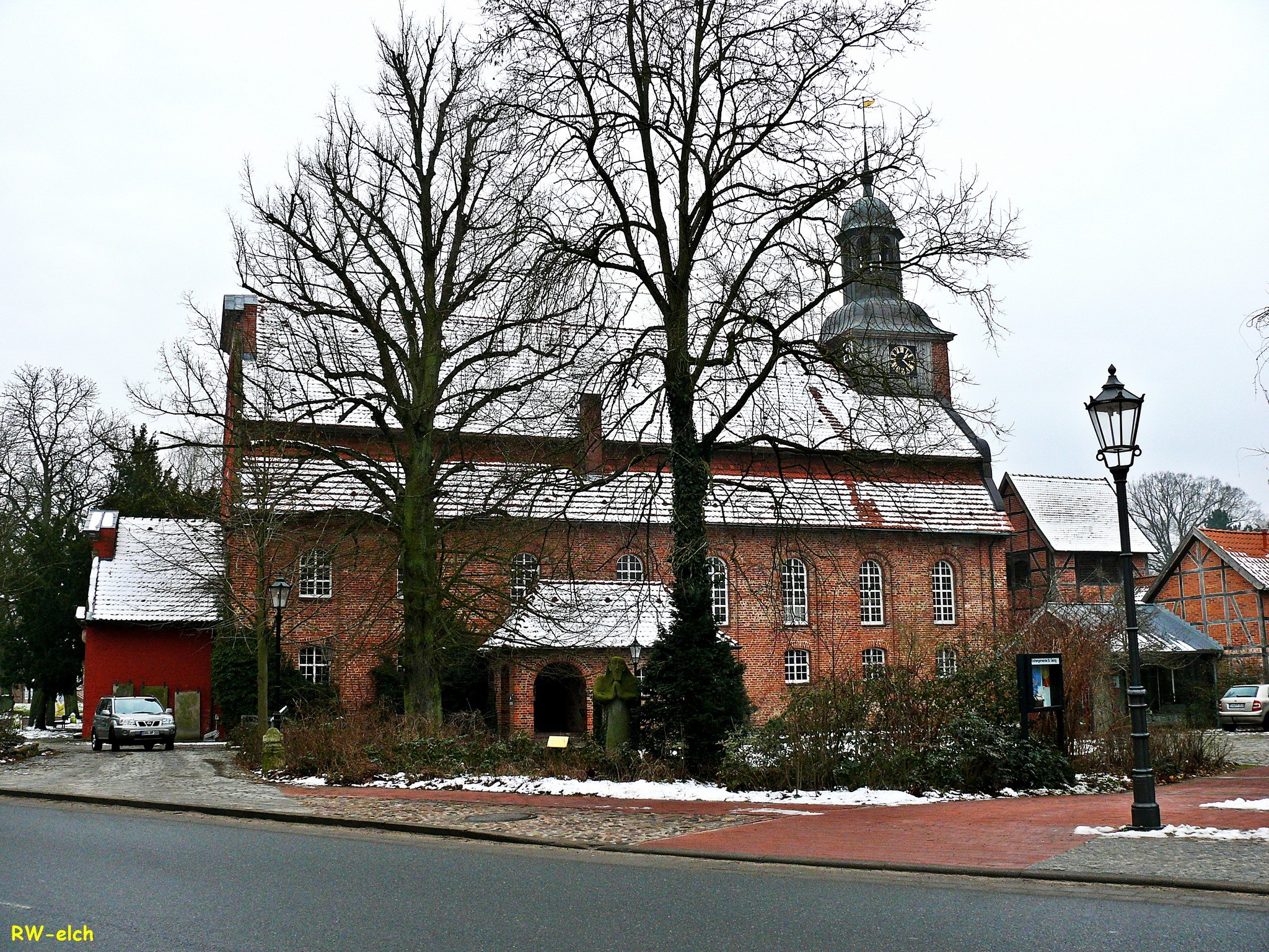 Brick church with clock tower in Gartow, Germany in winter HD Wallpaper