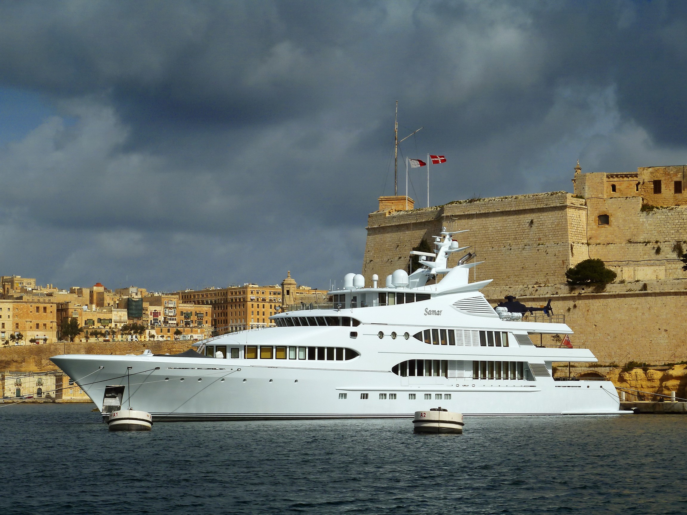 Superyacht Samar docked near fortified city HD Wallpaper