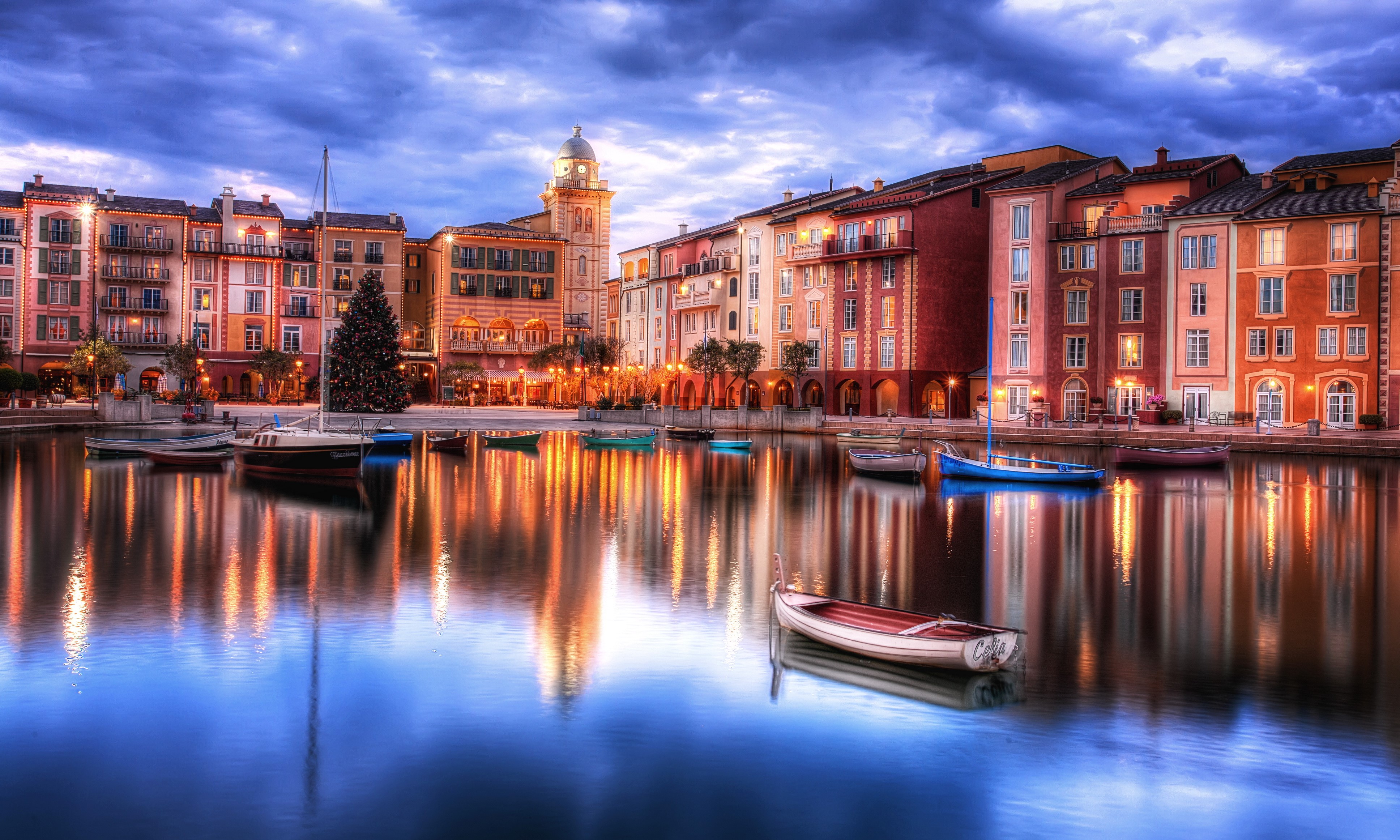 Boats on a canal in front of colorful buildings at dusk HD Wallpaper