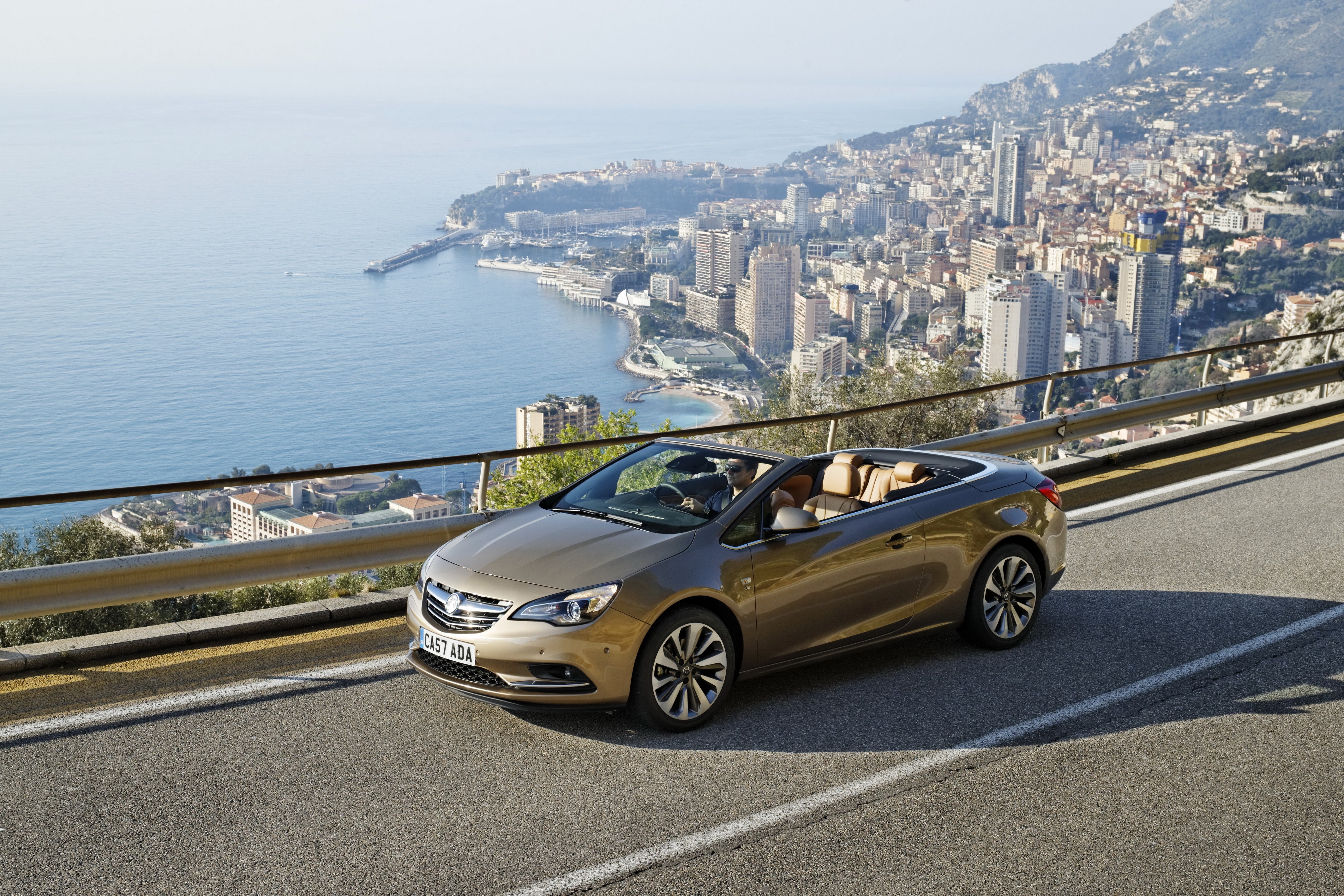 Vauxhall Cascada Cabriolet driving on a coastal road HD Wallpaper