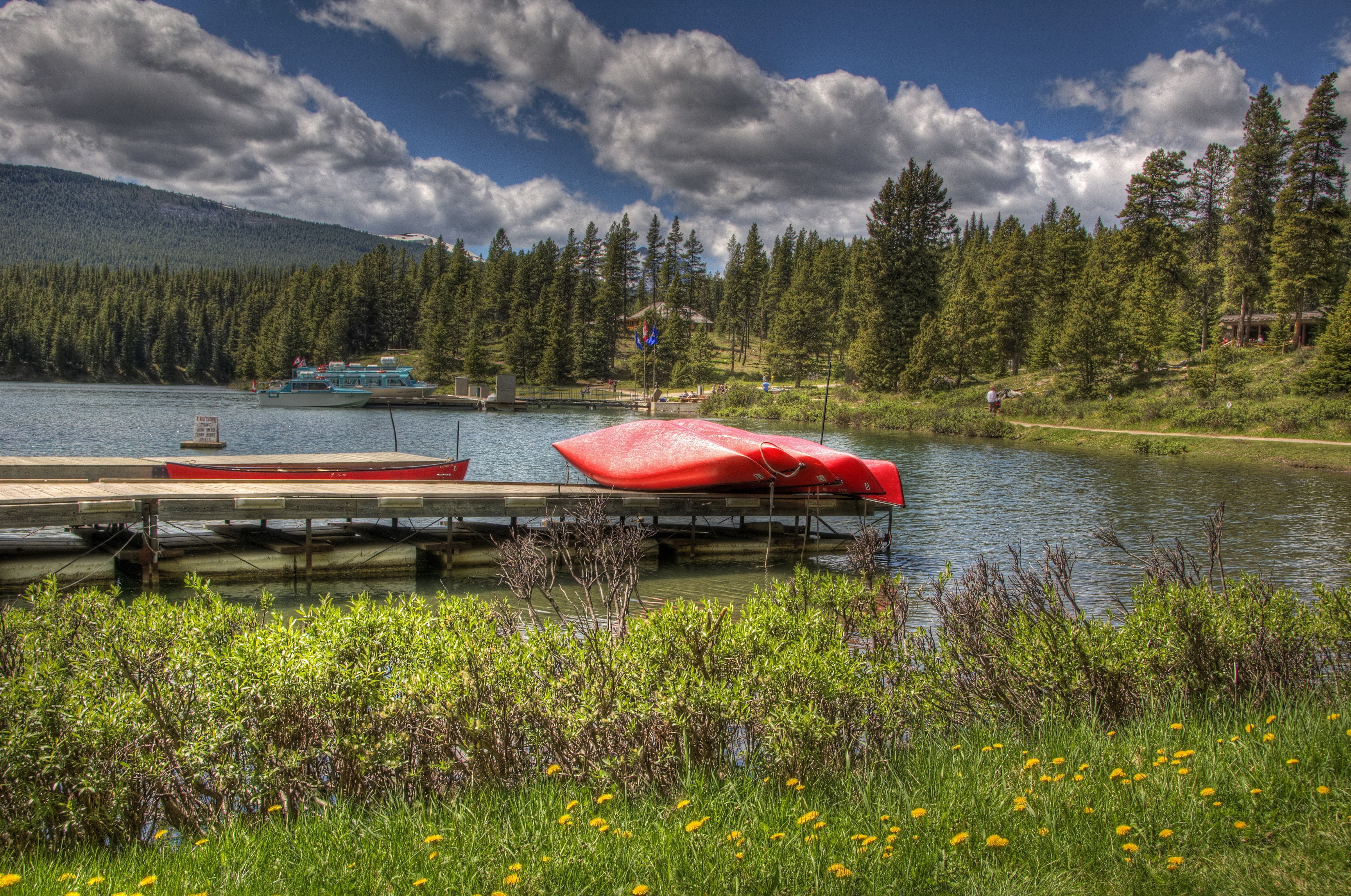 Canoes on a dock at Maligne Lake, Jasper National Park, Canada HD Wallpaper