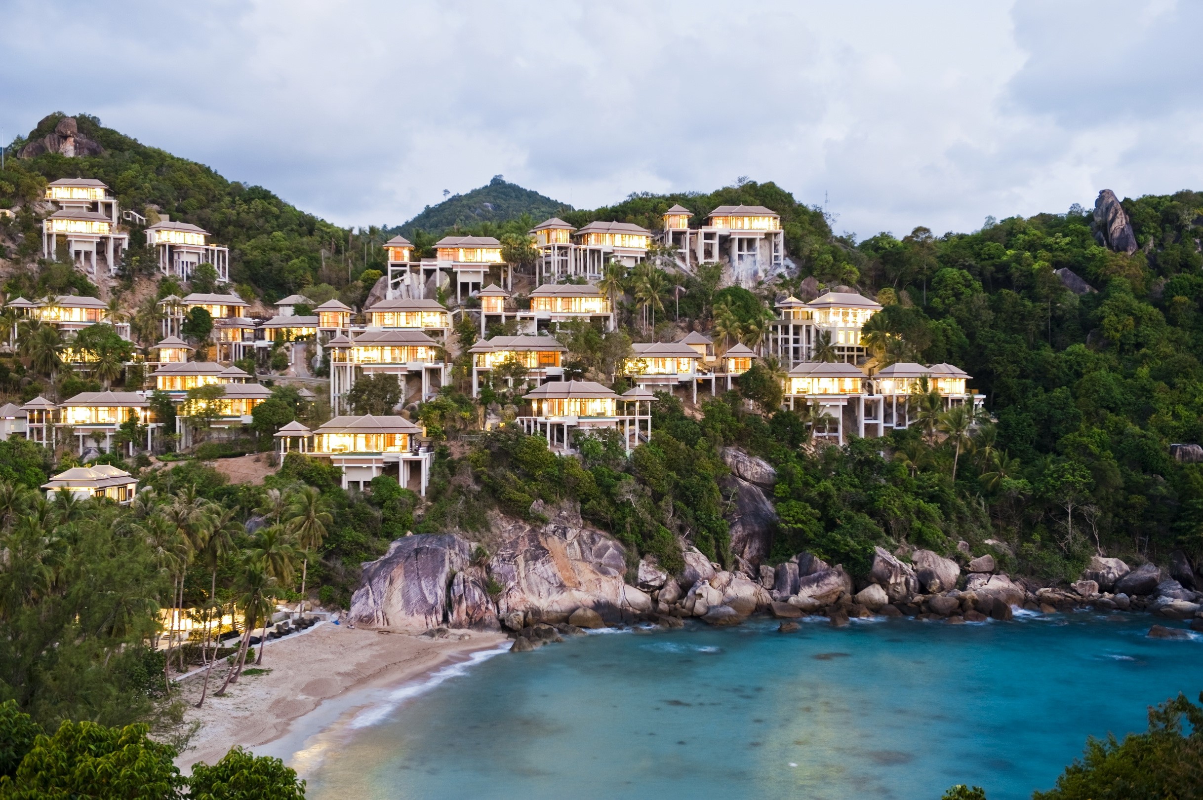 Luxury villas on a tropical hillside overlooking a cove in Thailand HD Wallpaper