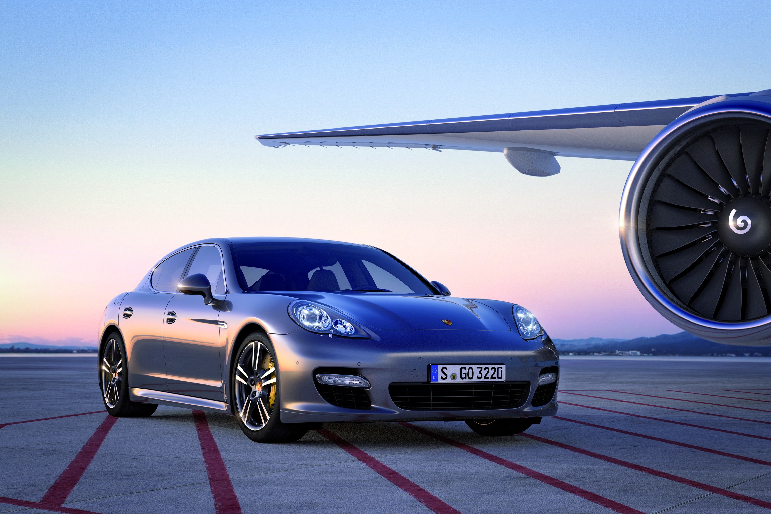 Porsche Panamera Turbo S parked next to airplane engine HD Wallpaper