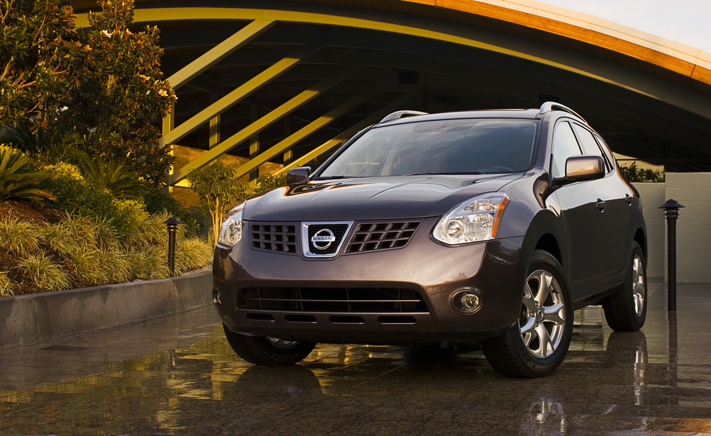2010 Nissan Rogue parked outside building HD Wallpaper