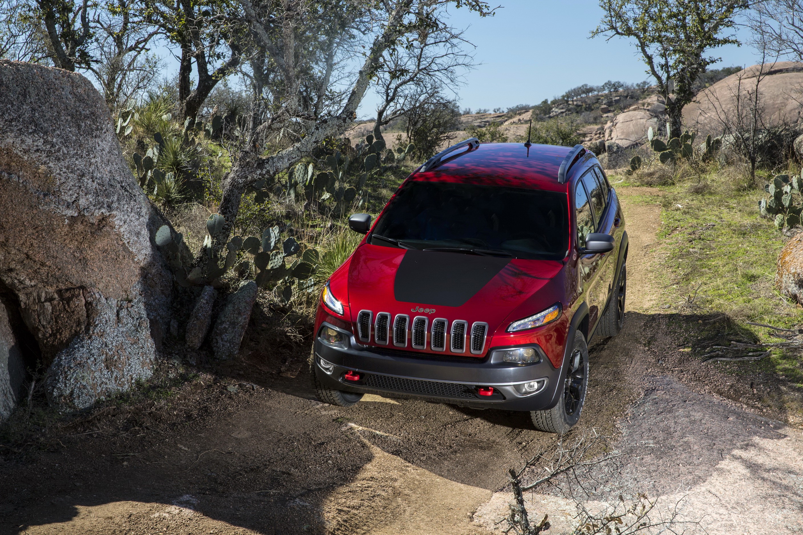 Red Jeep Cherokee Trailhawk on a dirt path HD Wallpaper