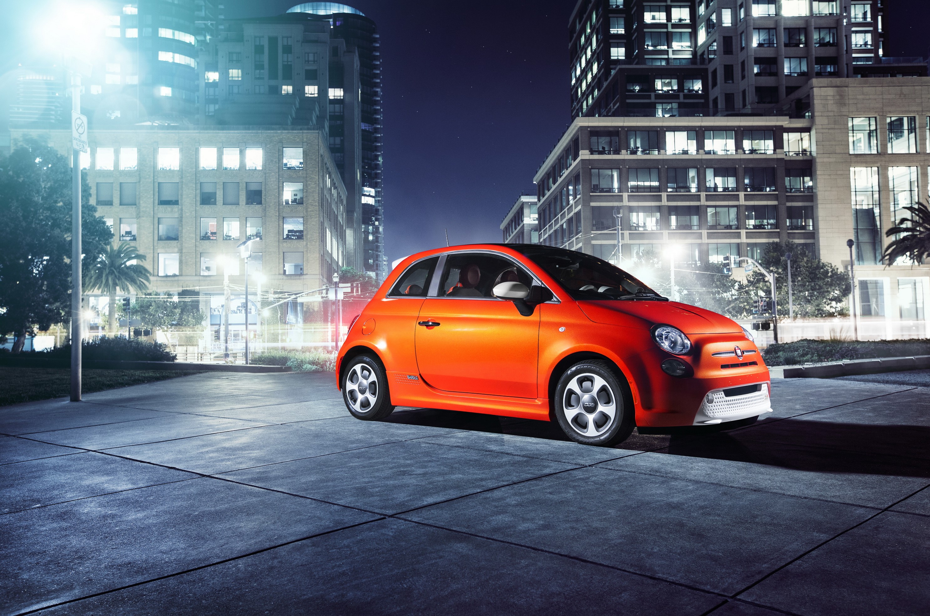 Orange 2013 Fiat 500e parked at night in a city HD Wallpaper