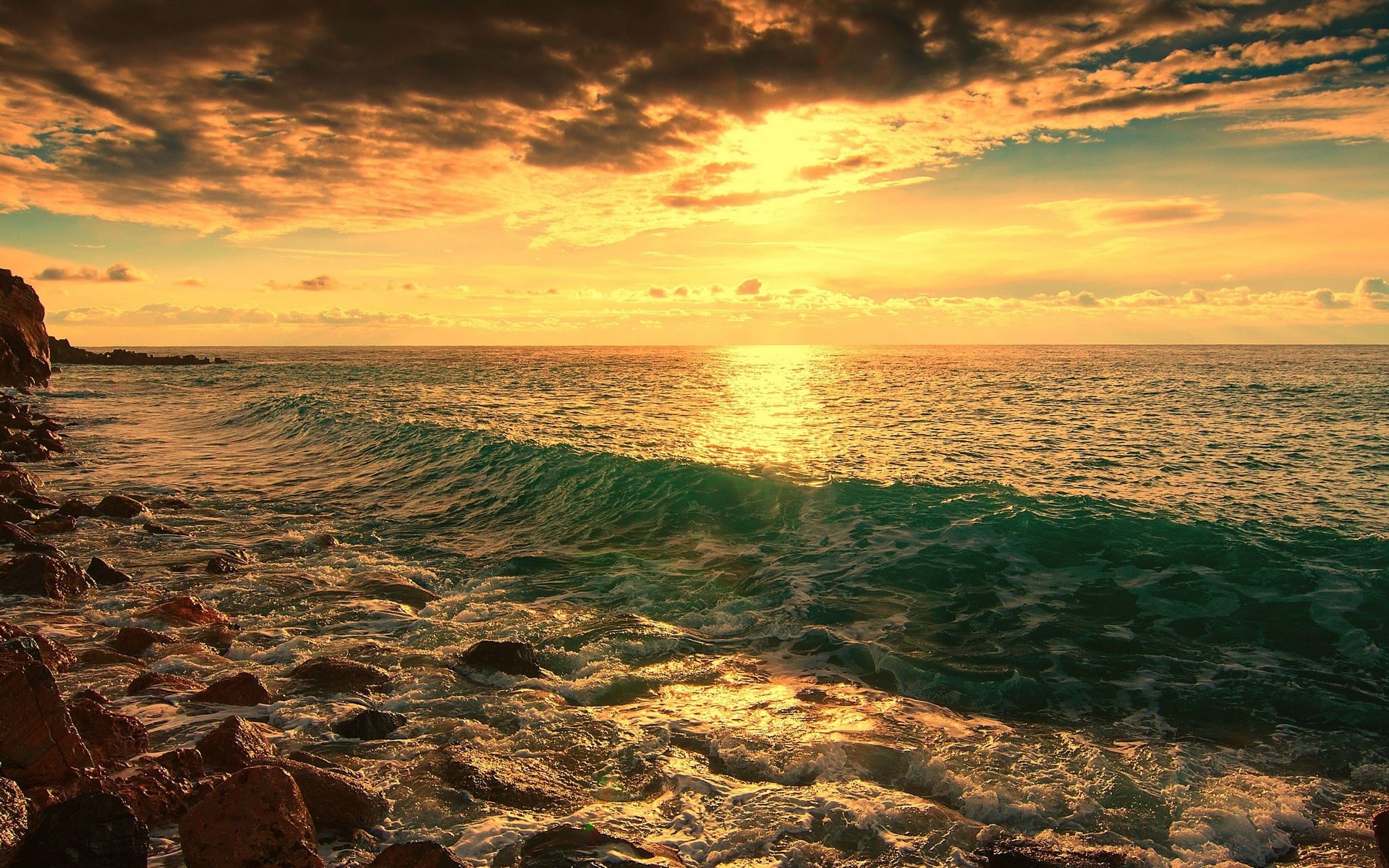Sunset over the ocean with rocky shore HD Wallpaper