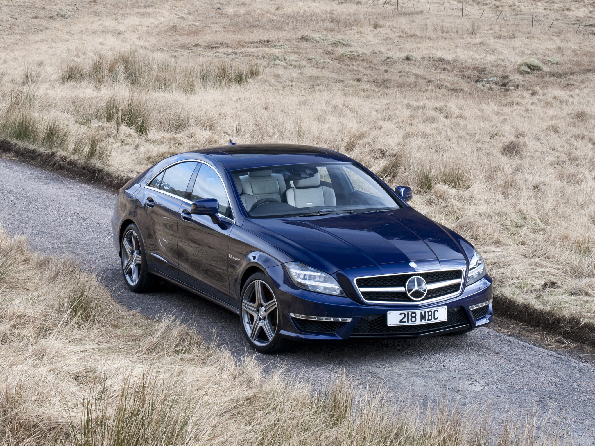 Blue 2011 Mercedes-Benz CLS63 C218 AMG on a dirt road HD Wallpaper