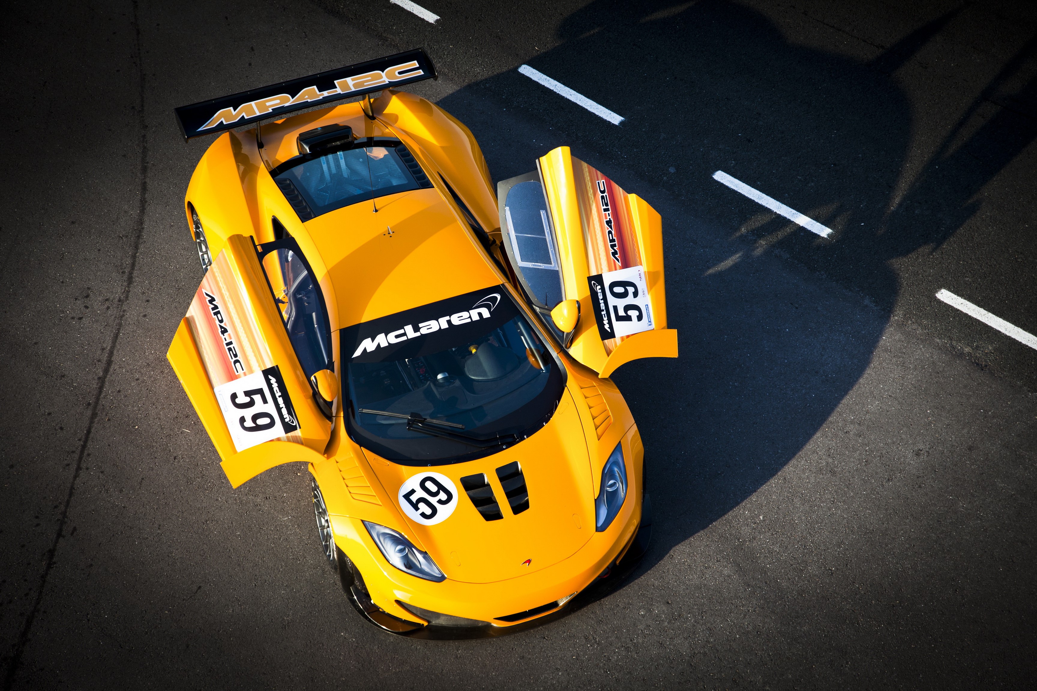 Yellow McLaren MP4-12C GT3 race car with doors open HD Wallpaper