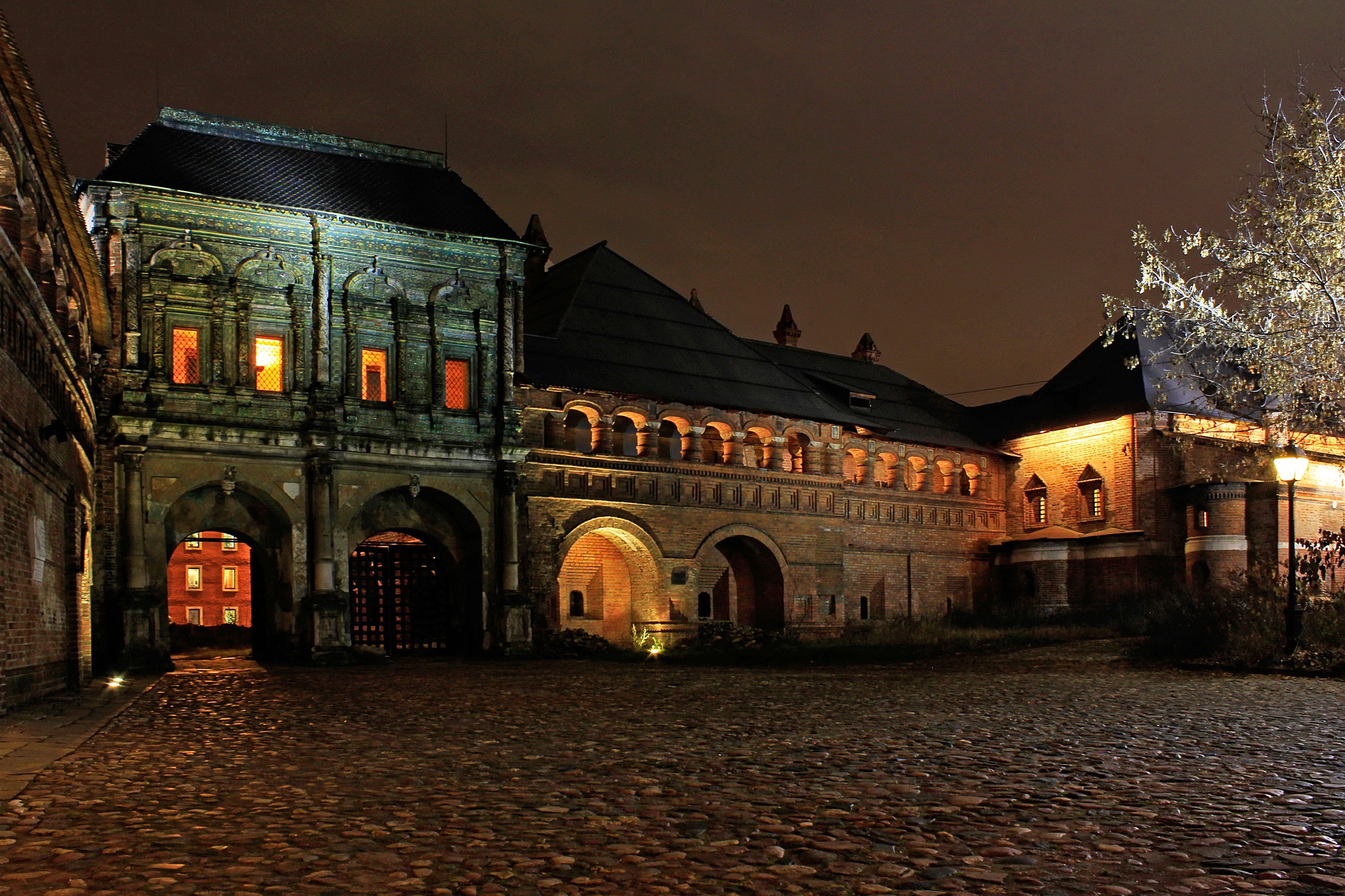 Old brick building with arched entrances at night HD Wallpaper