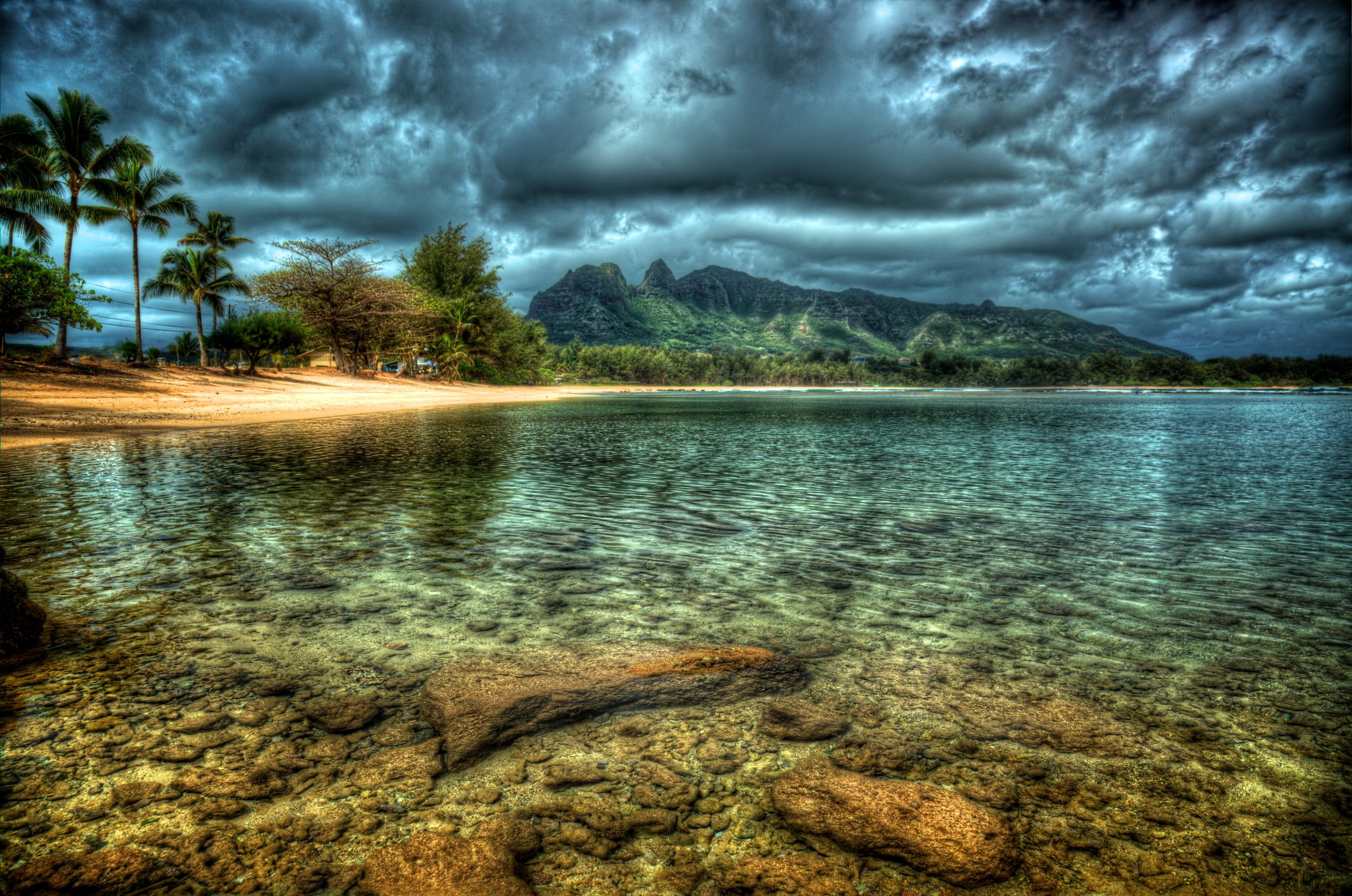 Tropical beach with mountains and stormy clouds HD Wallpaper