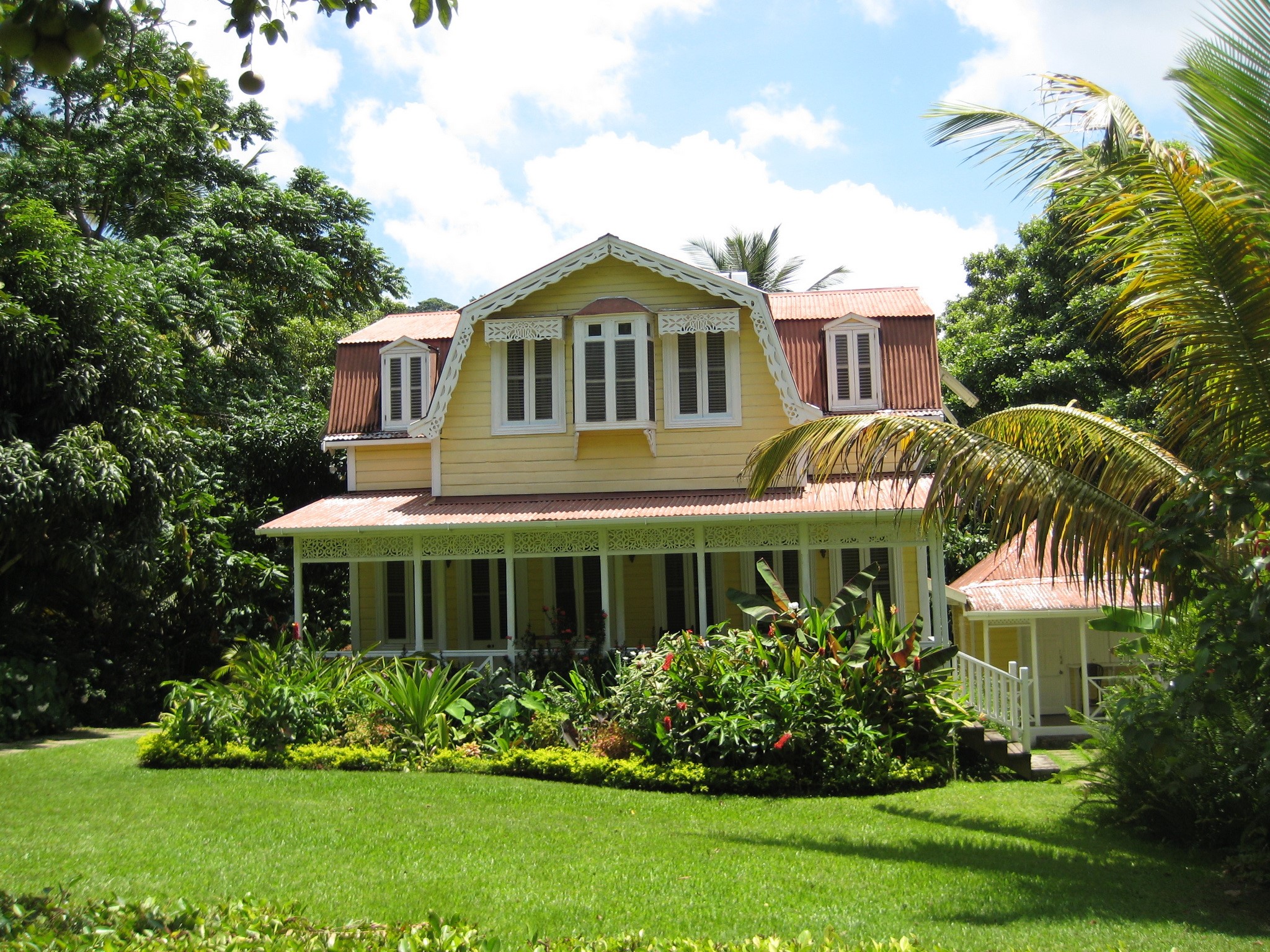 Yellow wooden house with red roof and garden HD Wallpaper