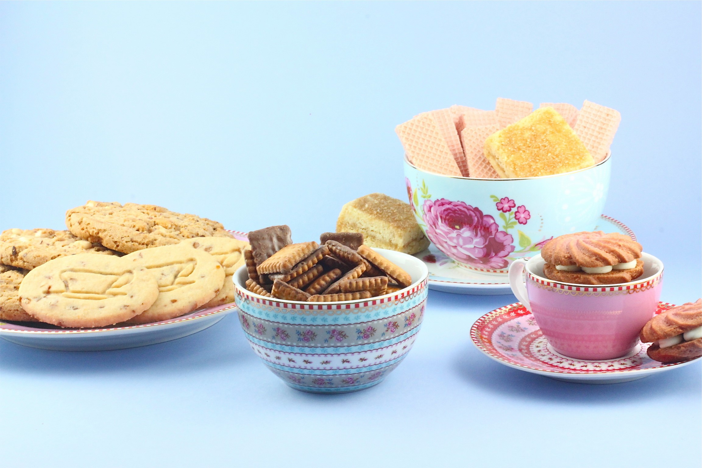 Assortment of cookies and wafers on a blue background HD Wallpaper
