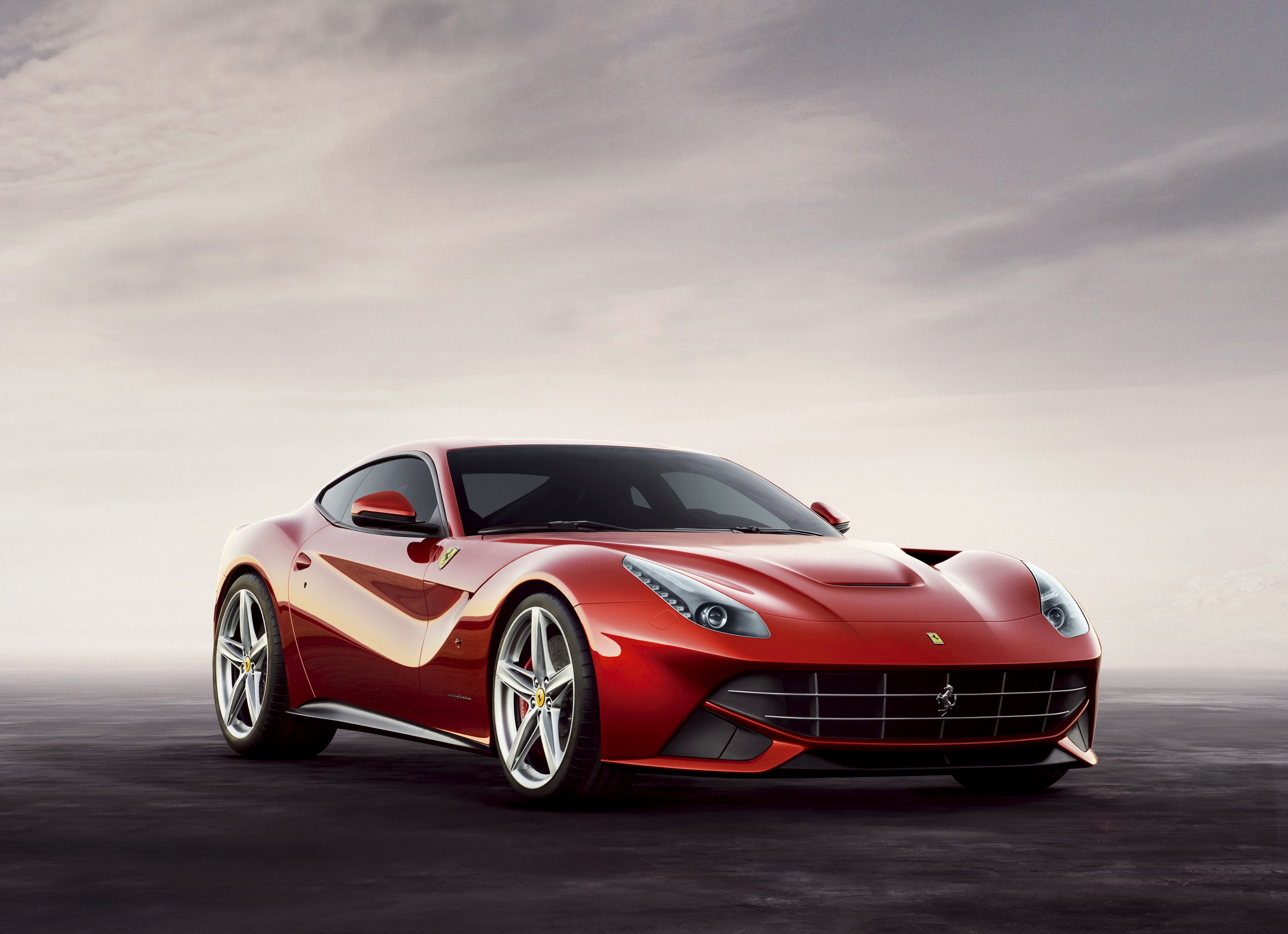 Red Ferrari F12berlinetta parked on dark surface HD Wallpaper