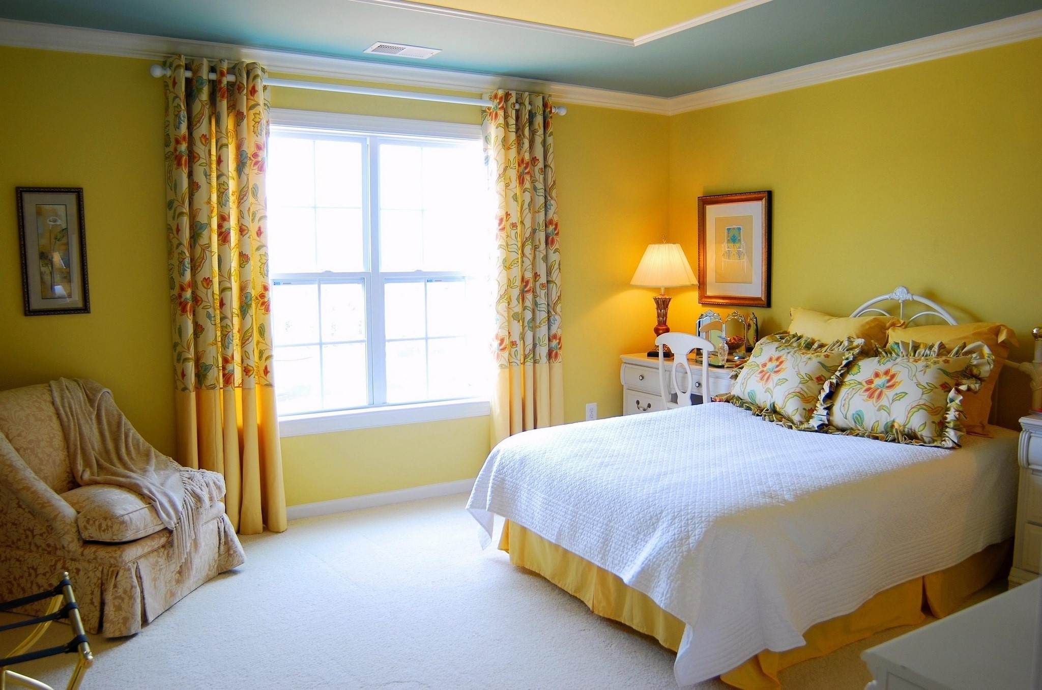 Yellow bedroom with floral curtains and a white bed HD Wallpaper