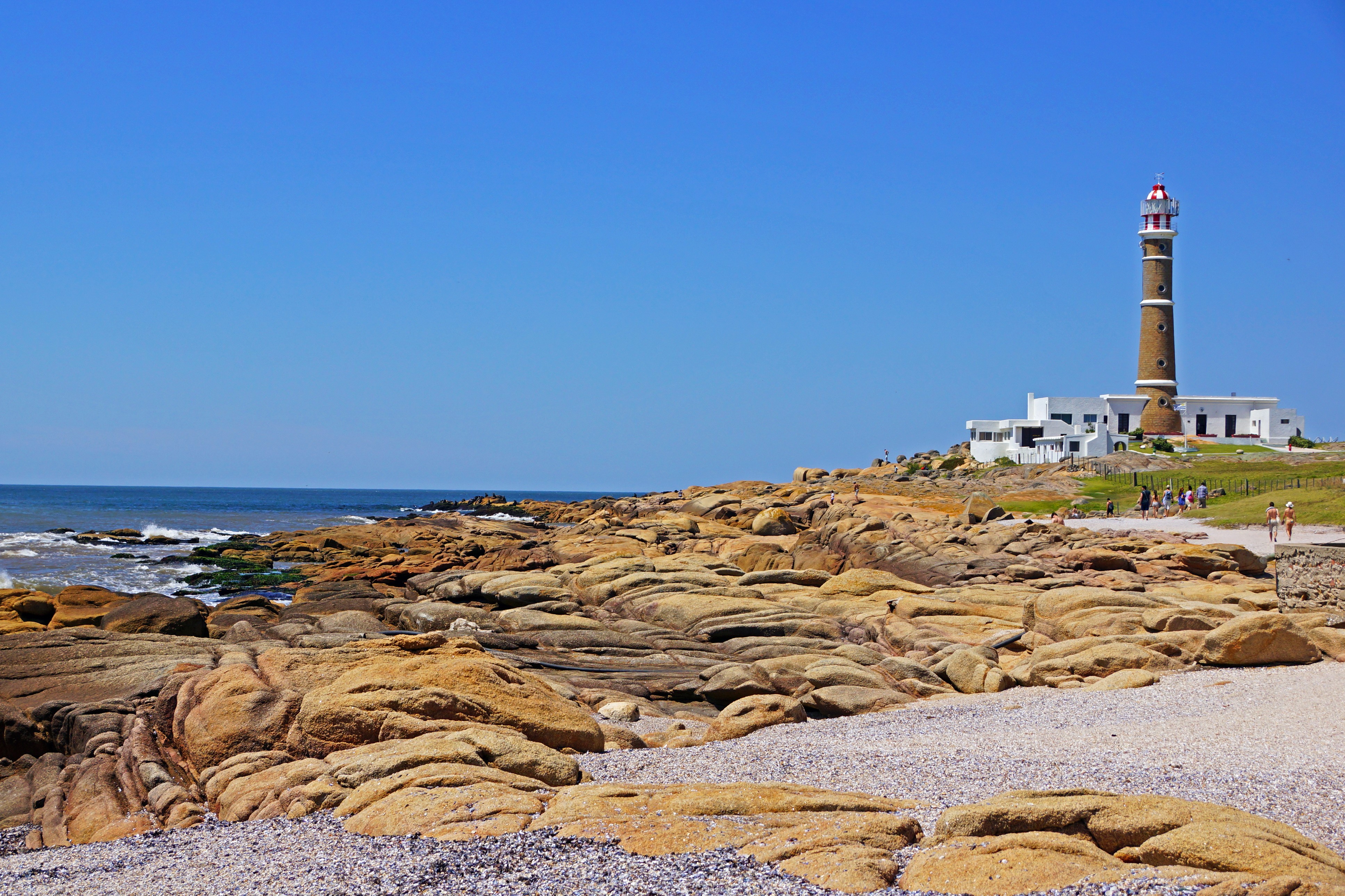 Lighthouse on rocky coast in Uruguay HD Wallpaper
