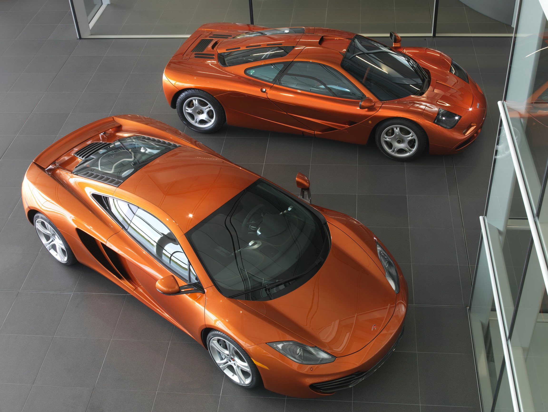 Two orange McLaren MP4-12C sports cars HD Wallpaper