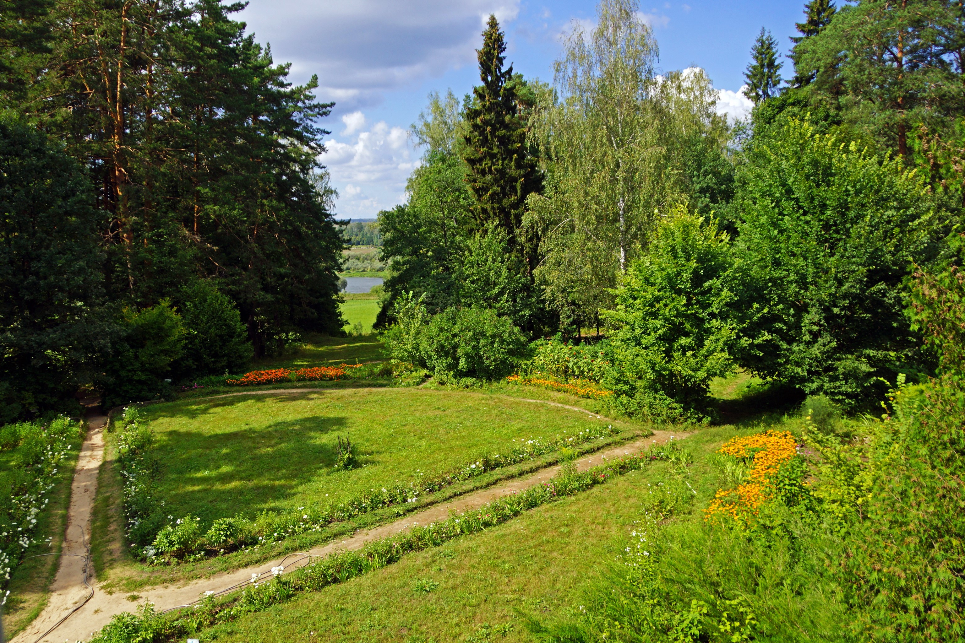 Park with trees, flowers, and a path in Russia HD Wallpaper
