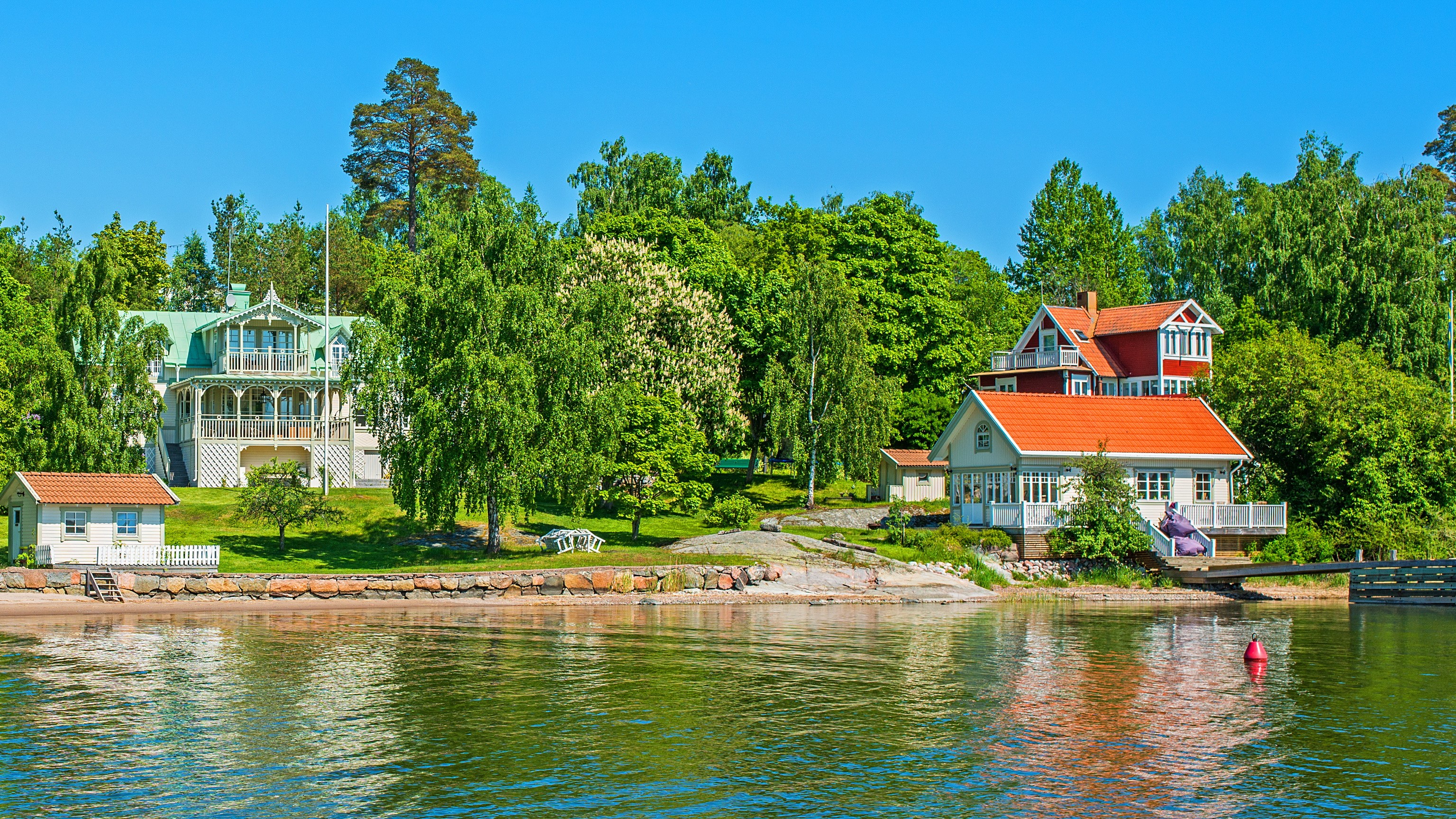 Houses on the shore of a river in Vaxholm, Sweden HD Wallpaper