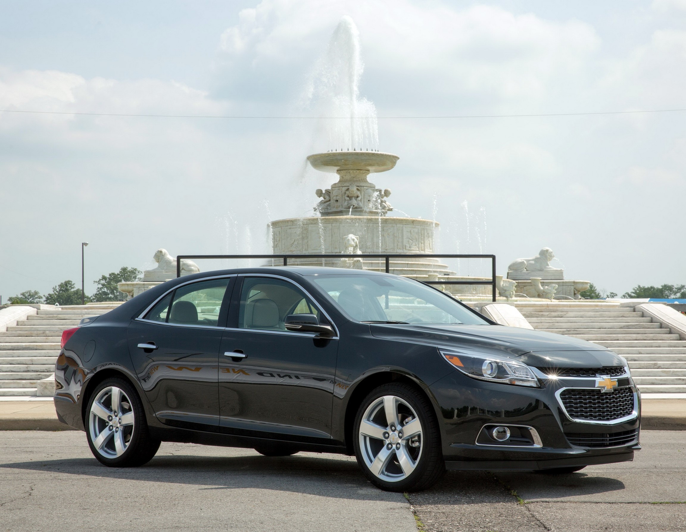 2014 Chevrolet Malibu parked near a fountain HD Wallpaper