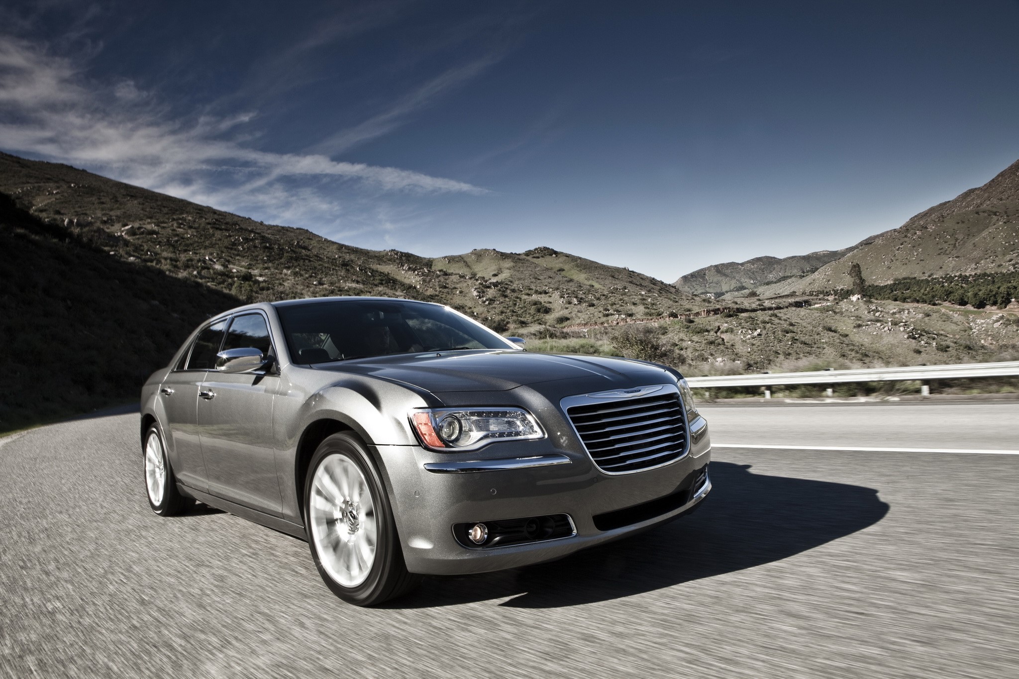 Chrysler 300 sedan driving on a mountain road HD Wallpaper