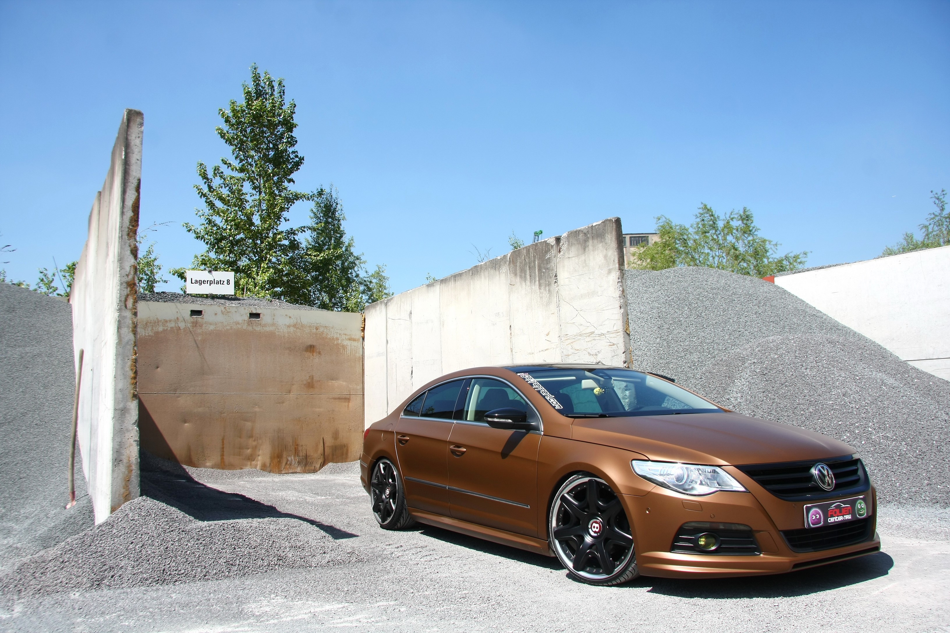 Brown Volkswagen CC parked near gravel piles HD Wallpaper