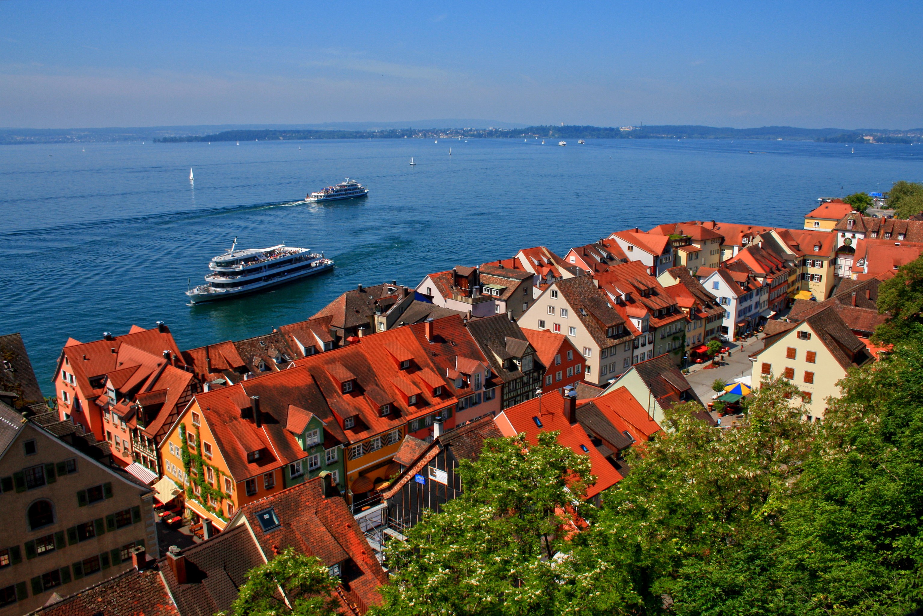 Meersburg, Germany houses overlooking a lake with boats HD Wallpaper