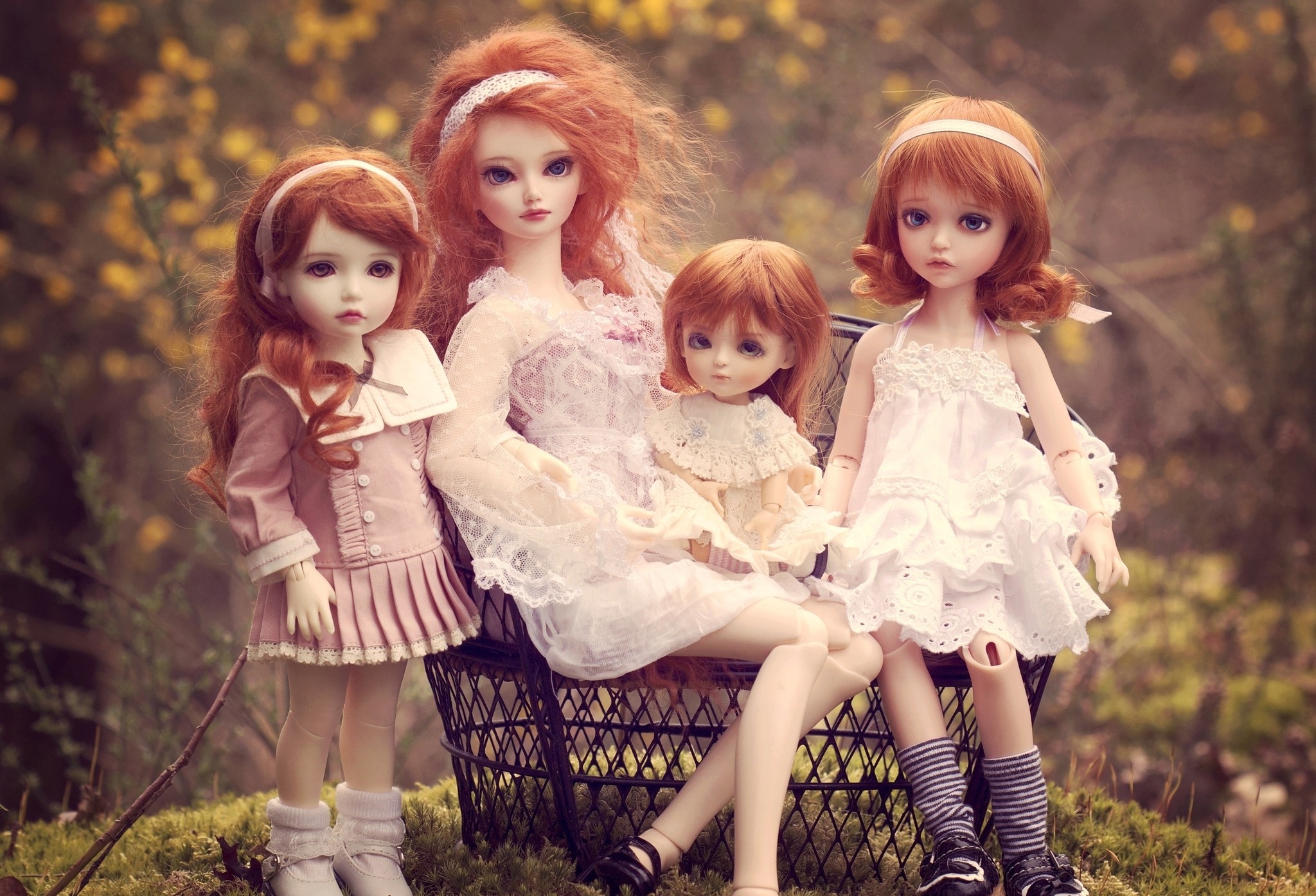 Four dolls with red hair sitting and standing outdoors HD Wallpaper