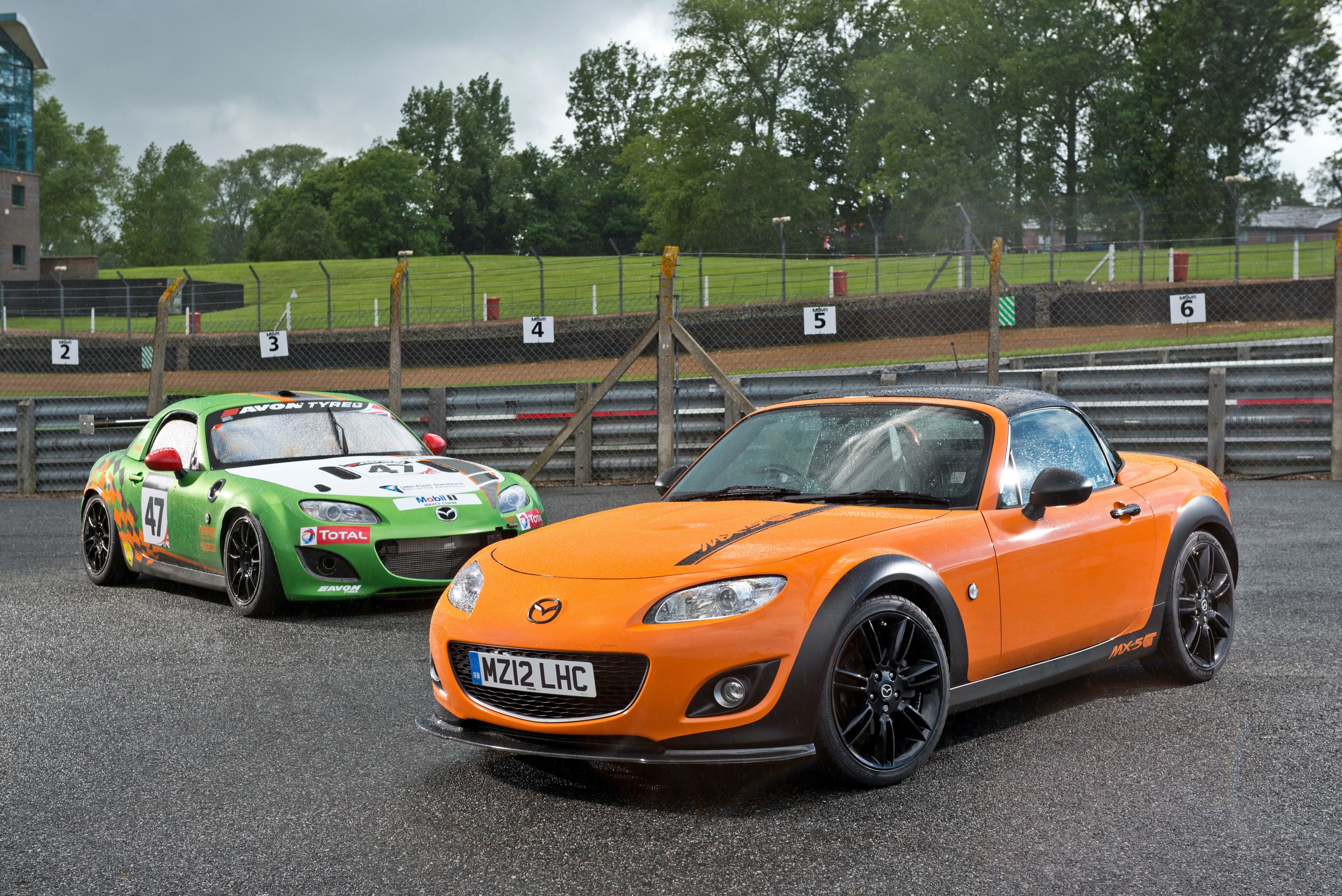 Orange and Green Mazda MX-5 GT cars on a race track HD Wallpaper