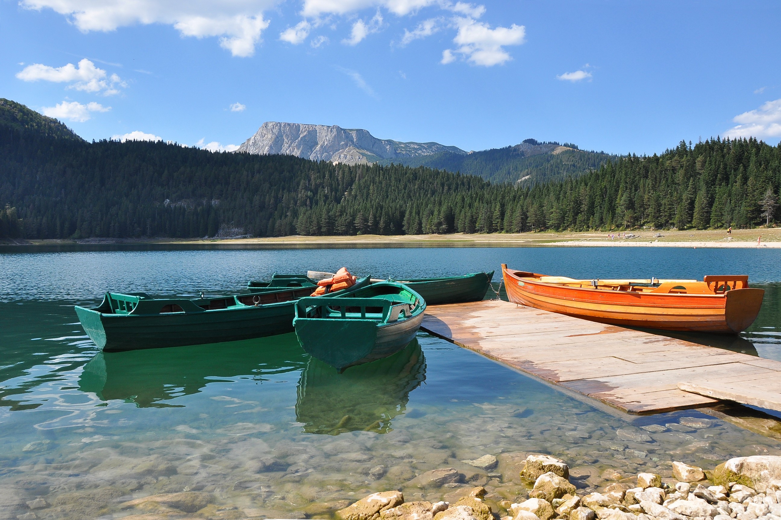Boats on a lake with mountains and forest in Montenegro HD Wallpaper