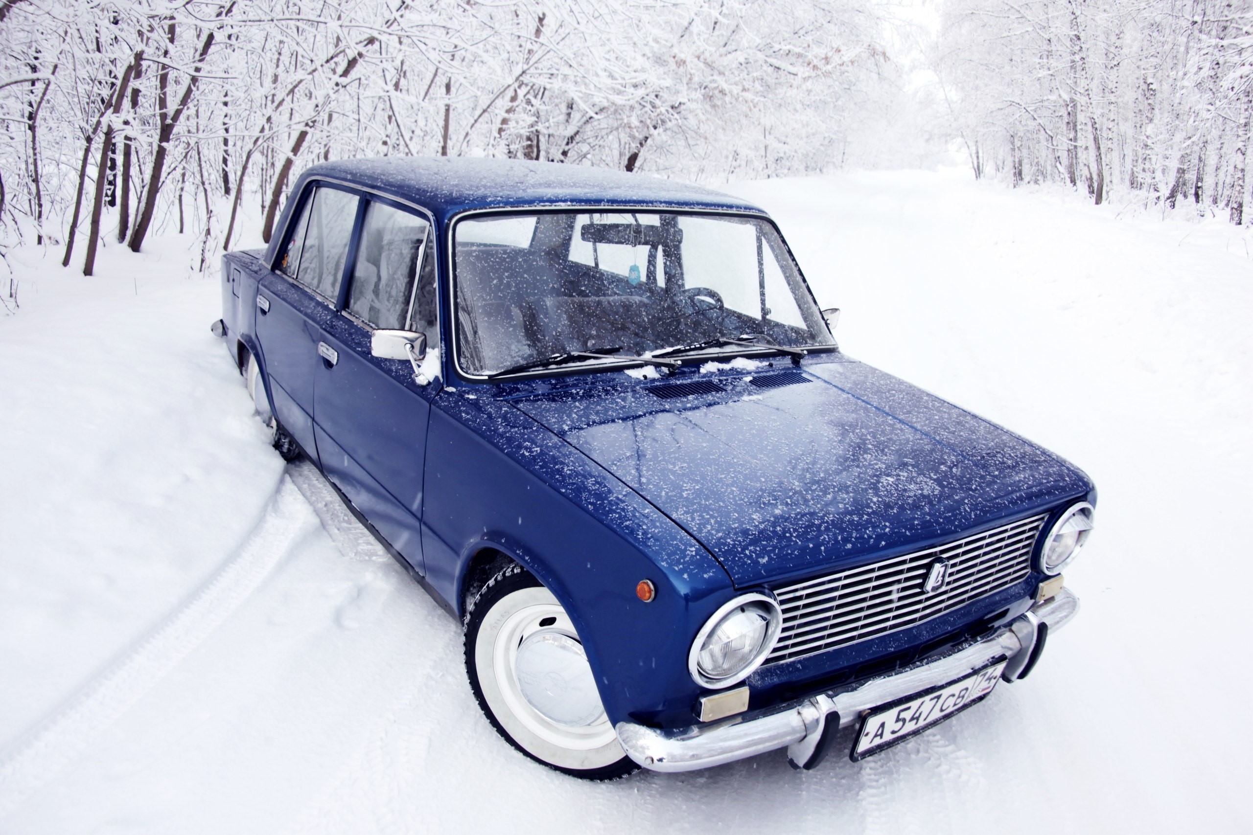 Blue VAZ-2101 car in a snowy forest HD Wallpaper