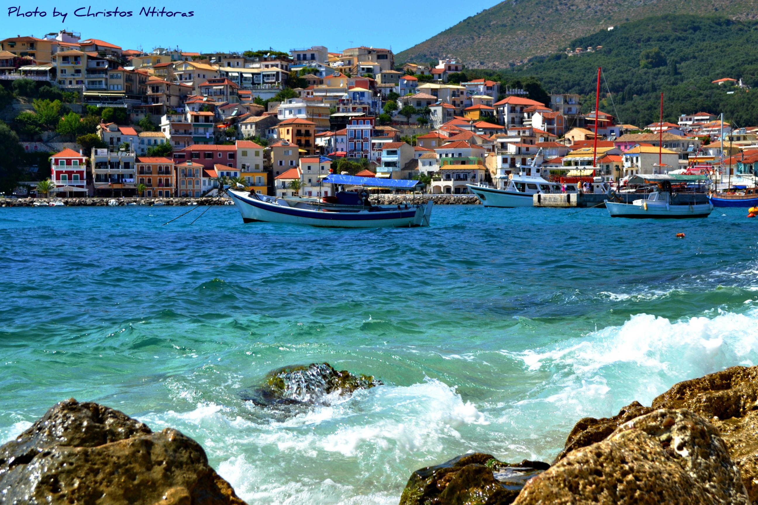 Boats in a bay with a town in Greece HD Wallpaper