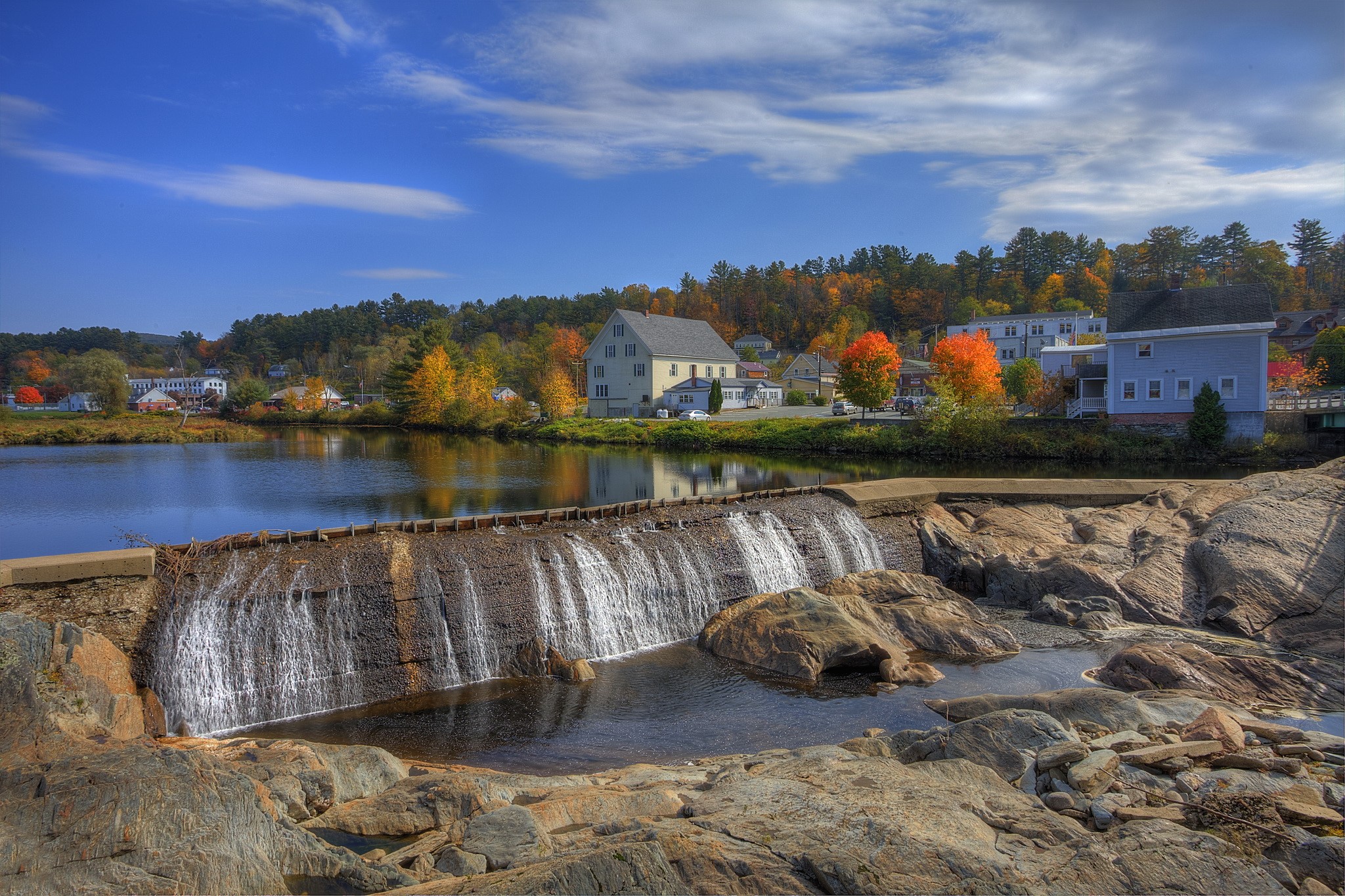 Waterfall dam in a town with autumn foliage HD Wallpaper