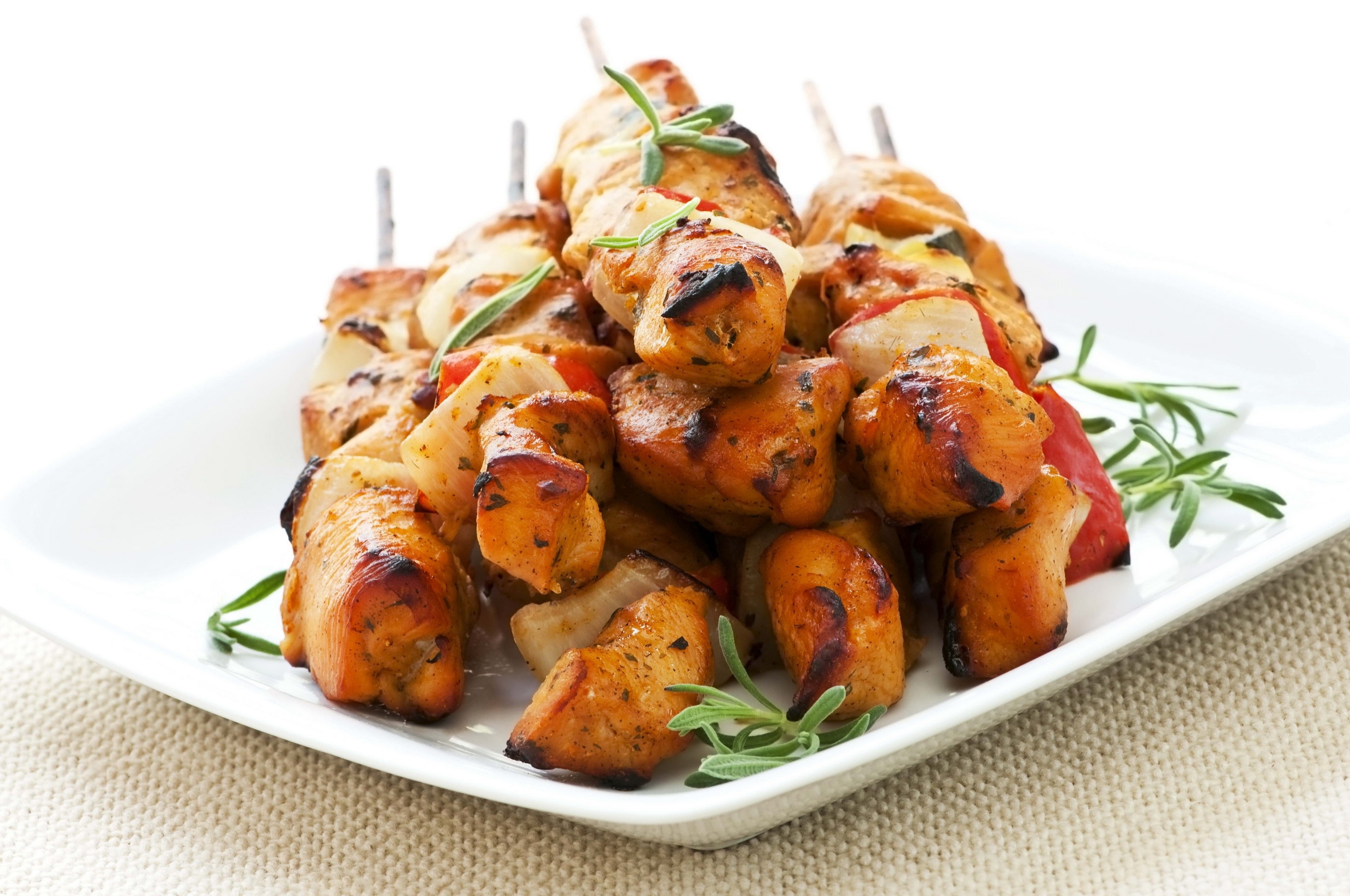 Chicken skewers with vegetables on a white plate HD Wallpaper