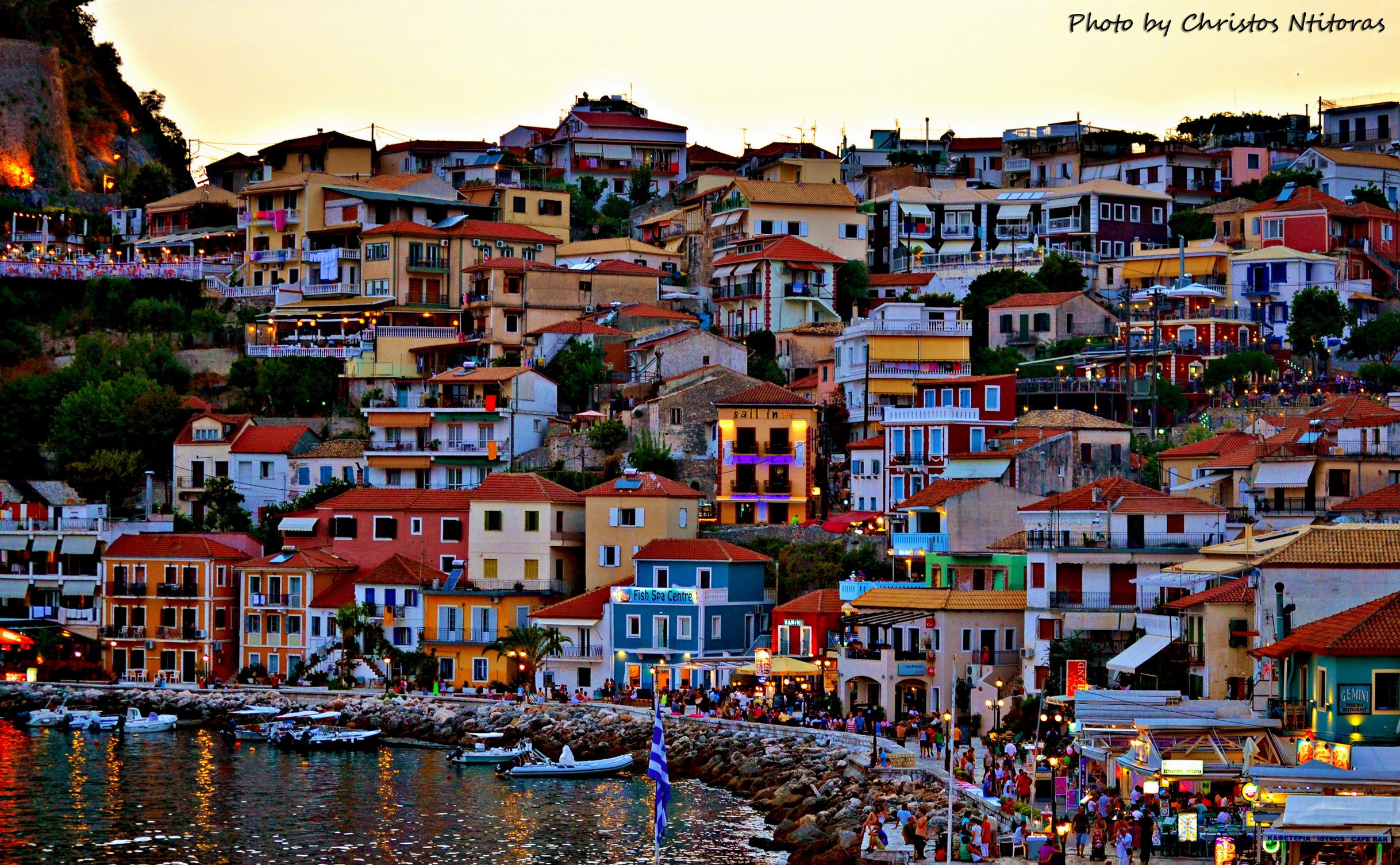 Colorful houses on a hillside overlooking a harbor in Greece HD Wallpaper