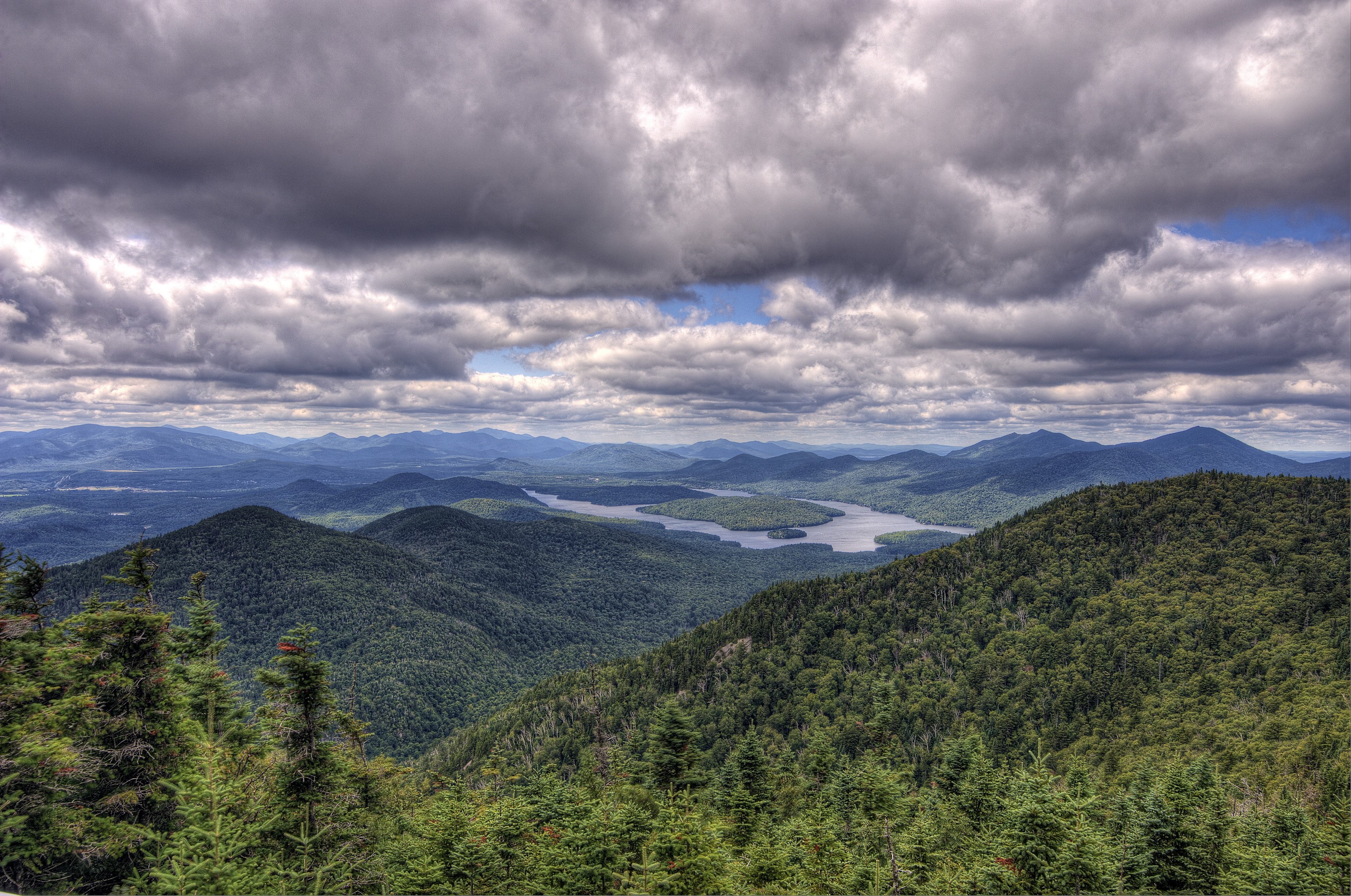 Mountainous landscape with a lake and cloudy sky HD Wallpaper