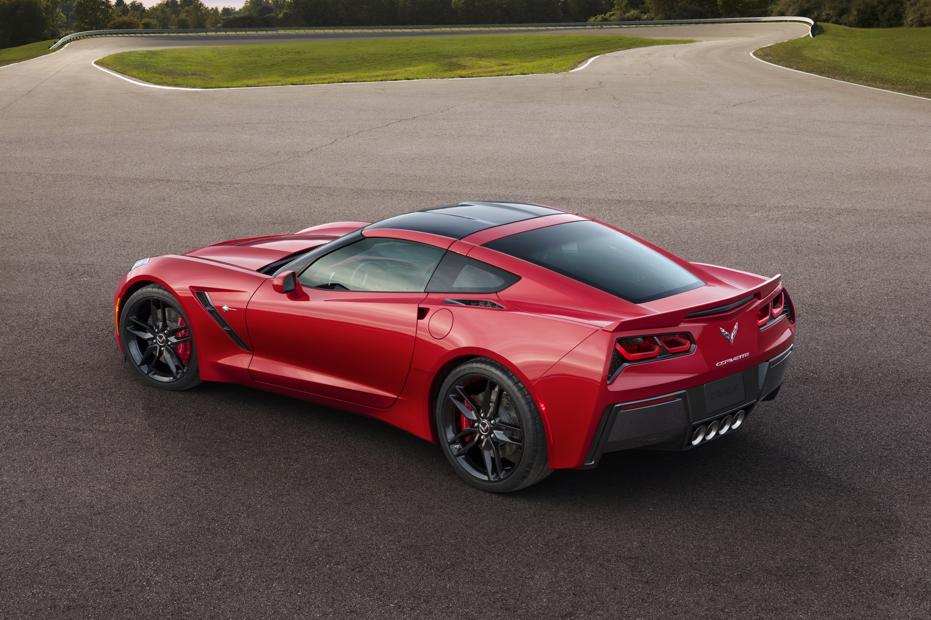 Red 2014 Chevrolet Corvette C7 Stingray on a Racetrack HD Wallpaper
