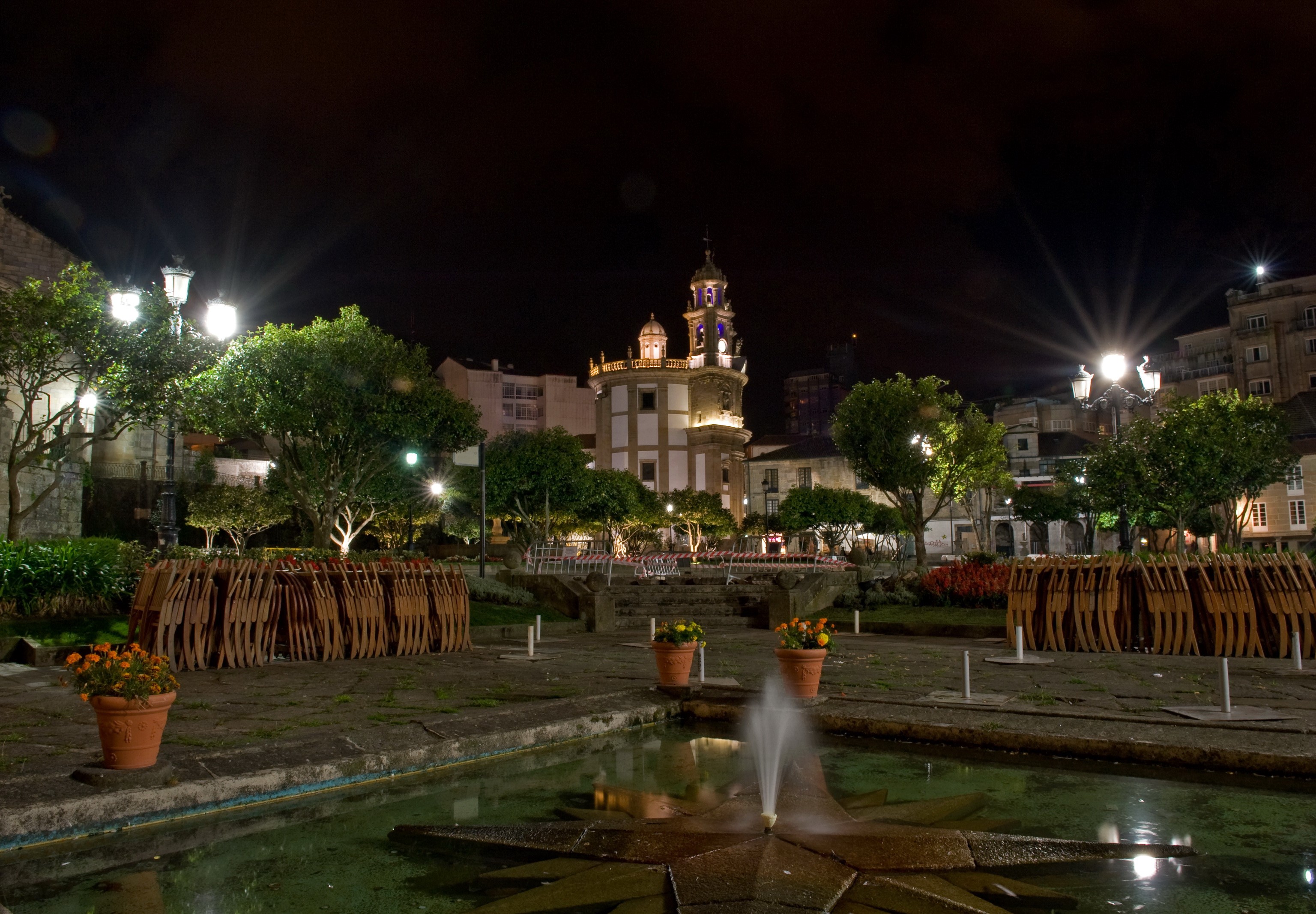 Plaza at night with fountain and church in Galicia, Spain HD Wallpaper