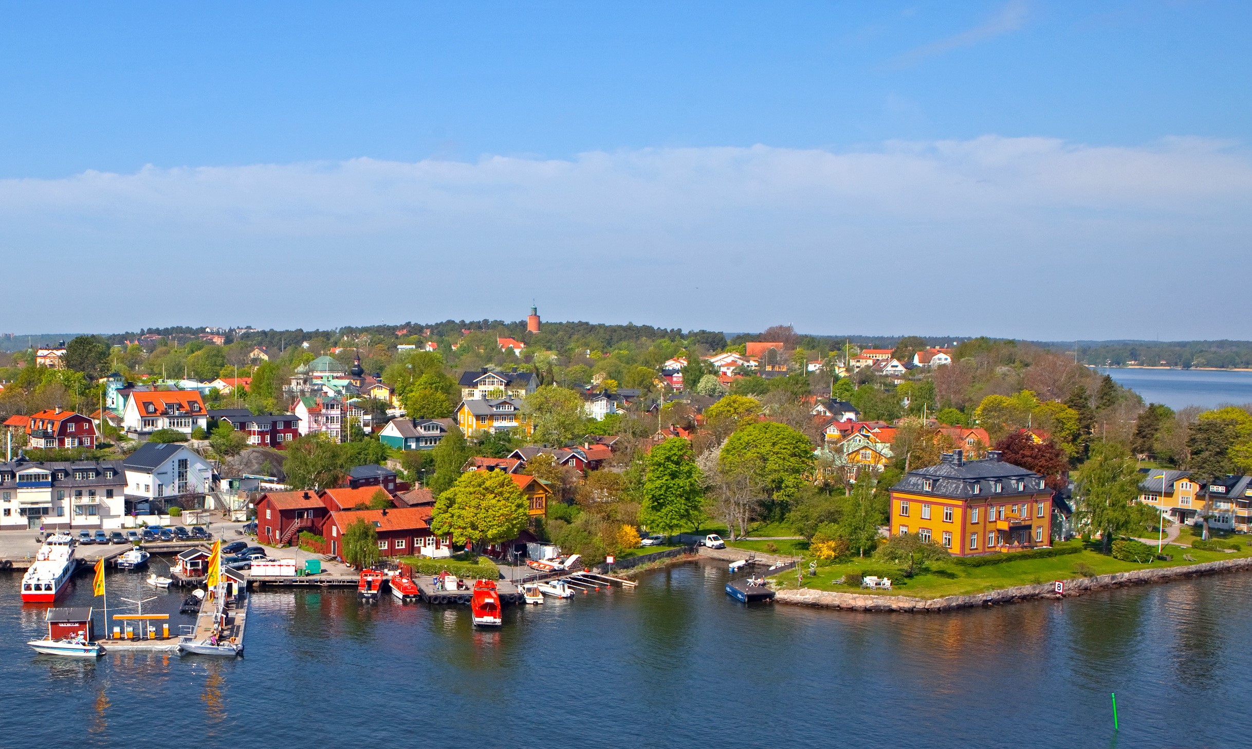 Waxholm, Sweden waterfront with colorful houses and boats HD Wallpaper