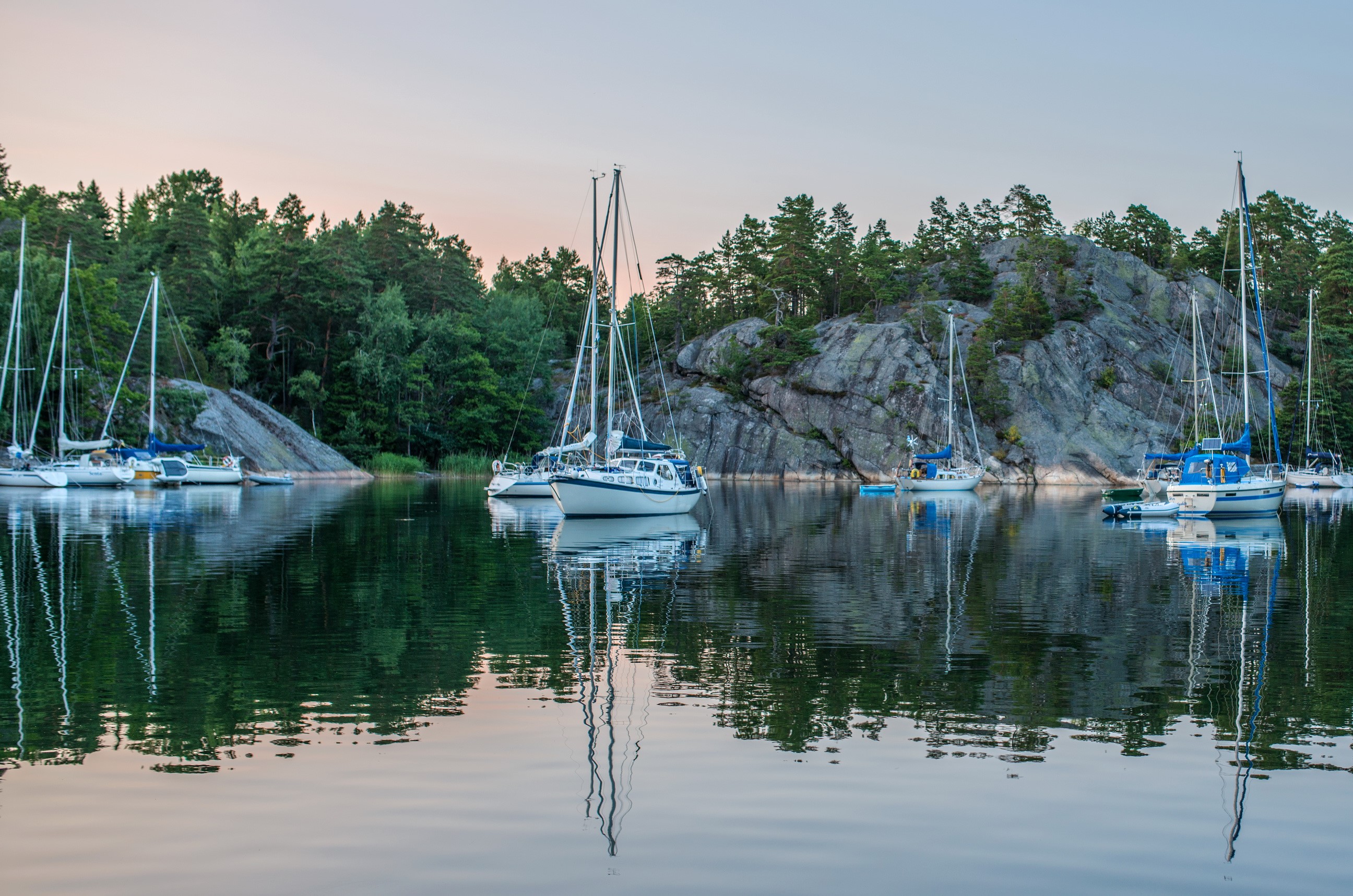 Sailboats docked in a rocky bay in Sweden HD Wallpaper