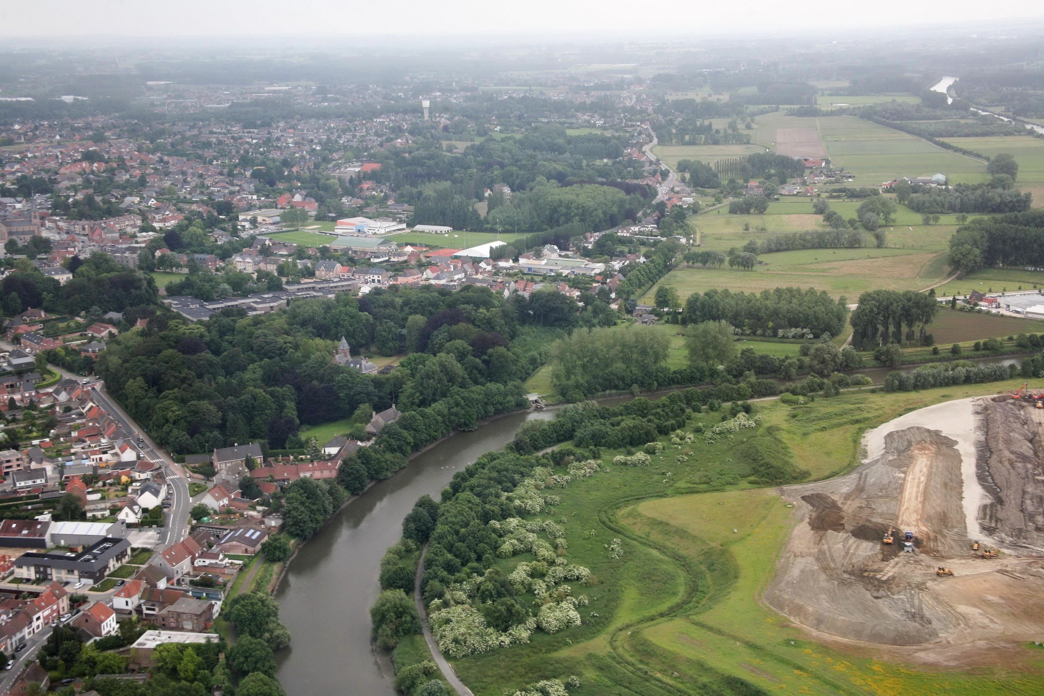 Aerial view of Merelbeke, Belgium with a river and construction site HD Wallpaper
