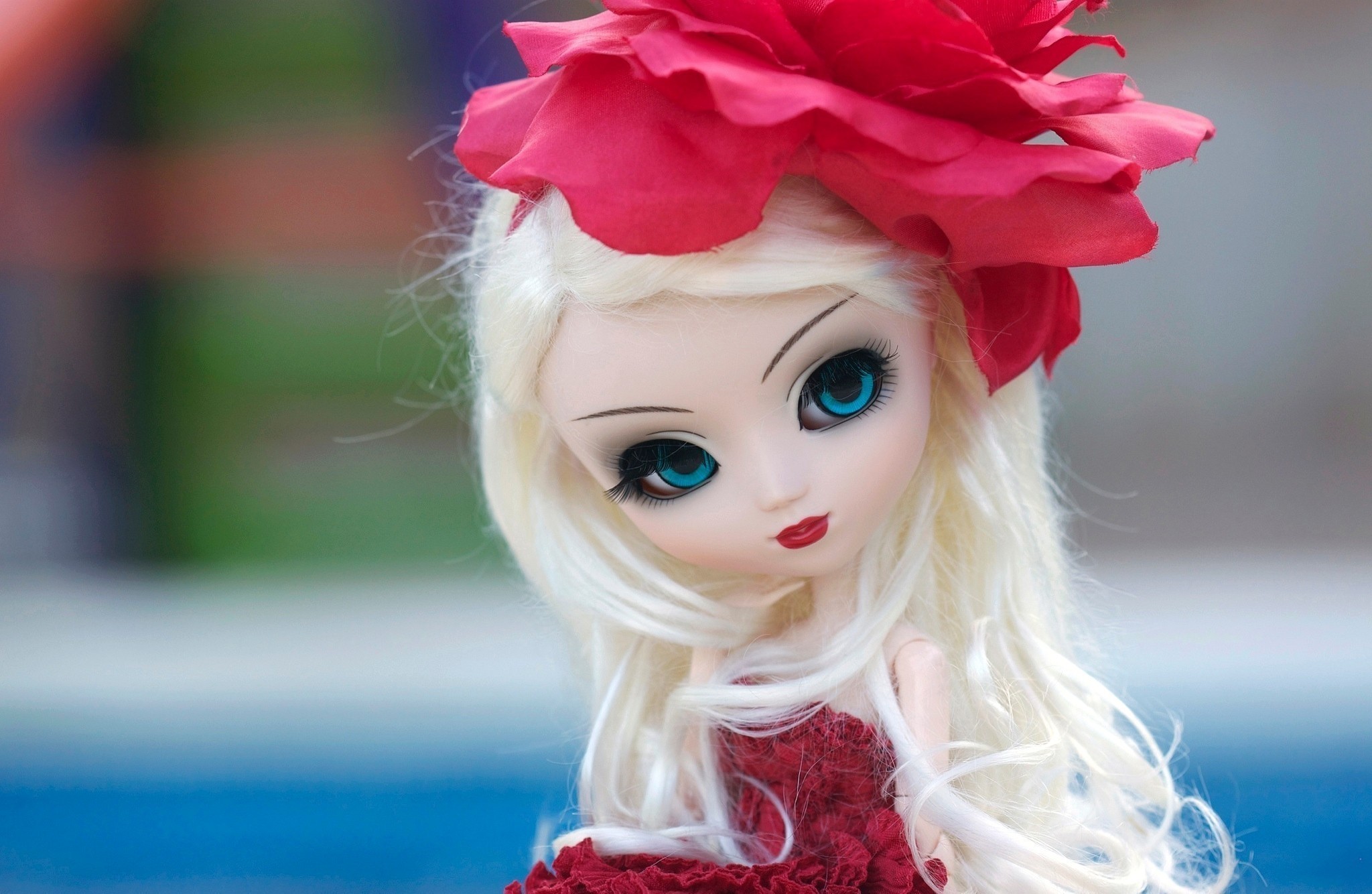 Doll with blonde hair and red flower HD Wallpaper