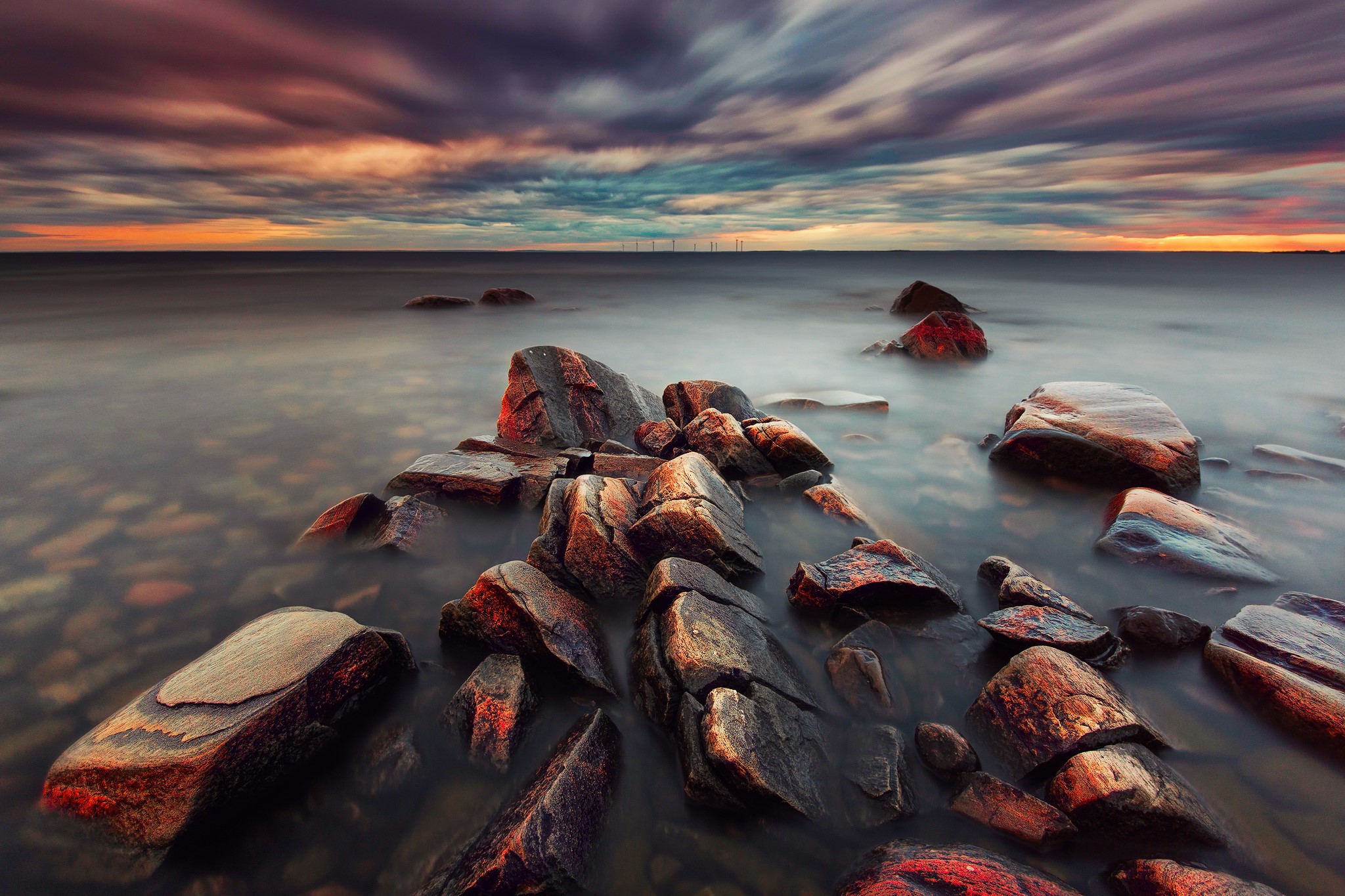 Rocks in the sea at sunset with clouds HD Wallpaper