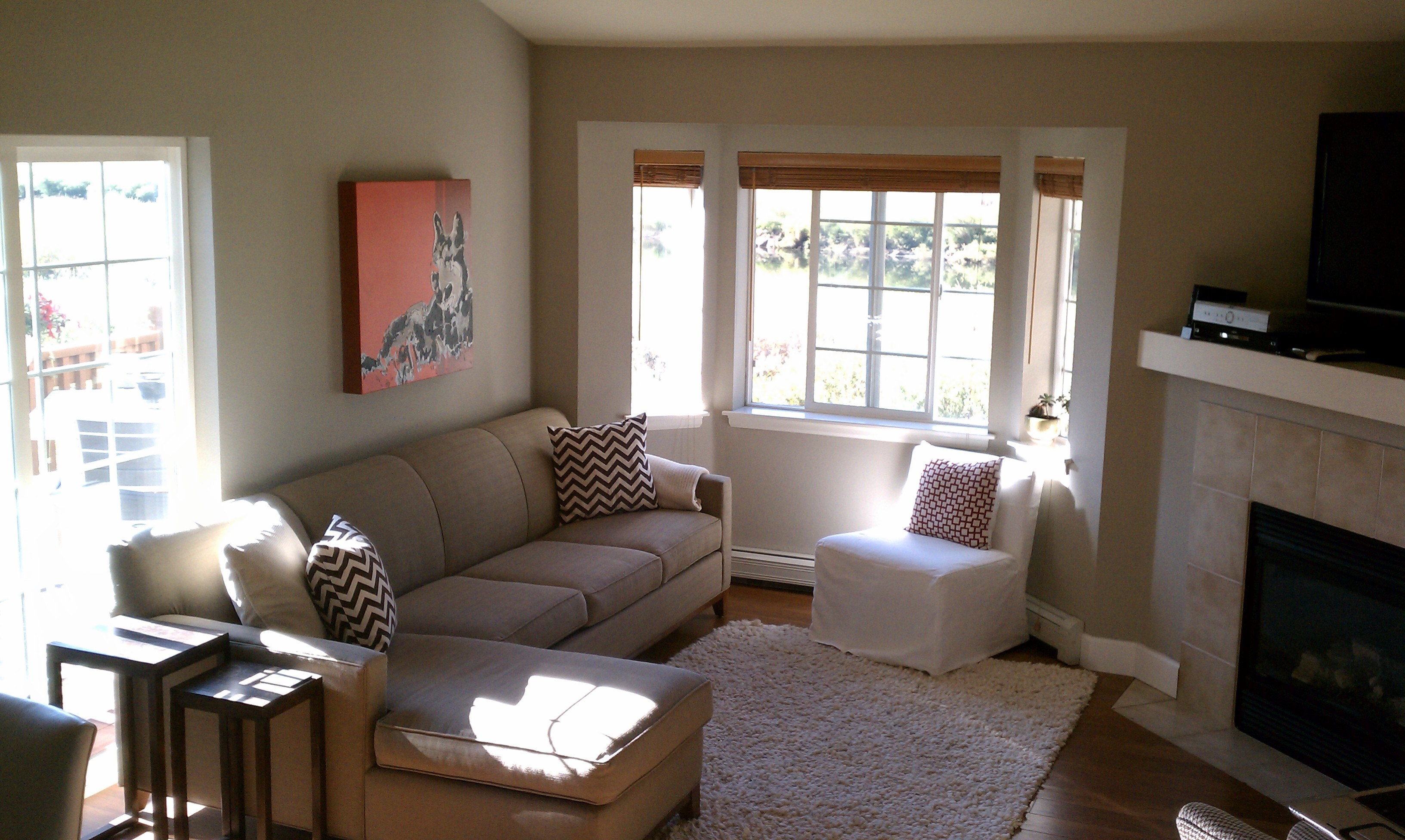 Living room with sofa, armchair, fireplace, and window HD Wallpaper