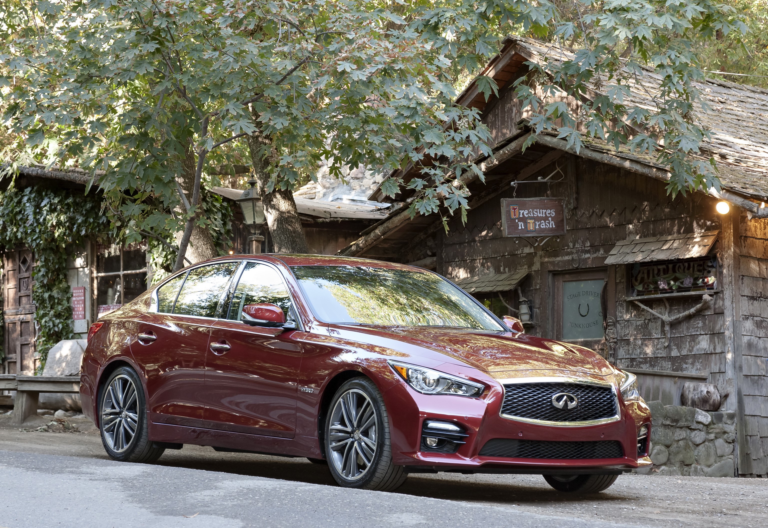 2013 Infiniti Q50S parked near a rustic building HD Wallpaper
