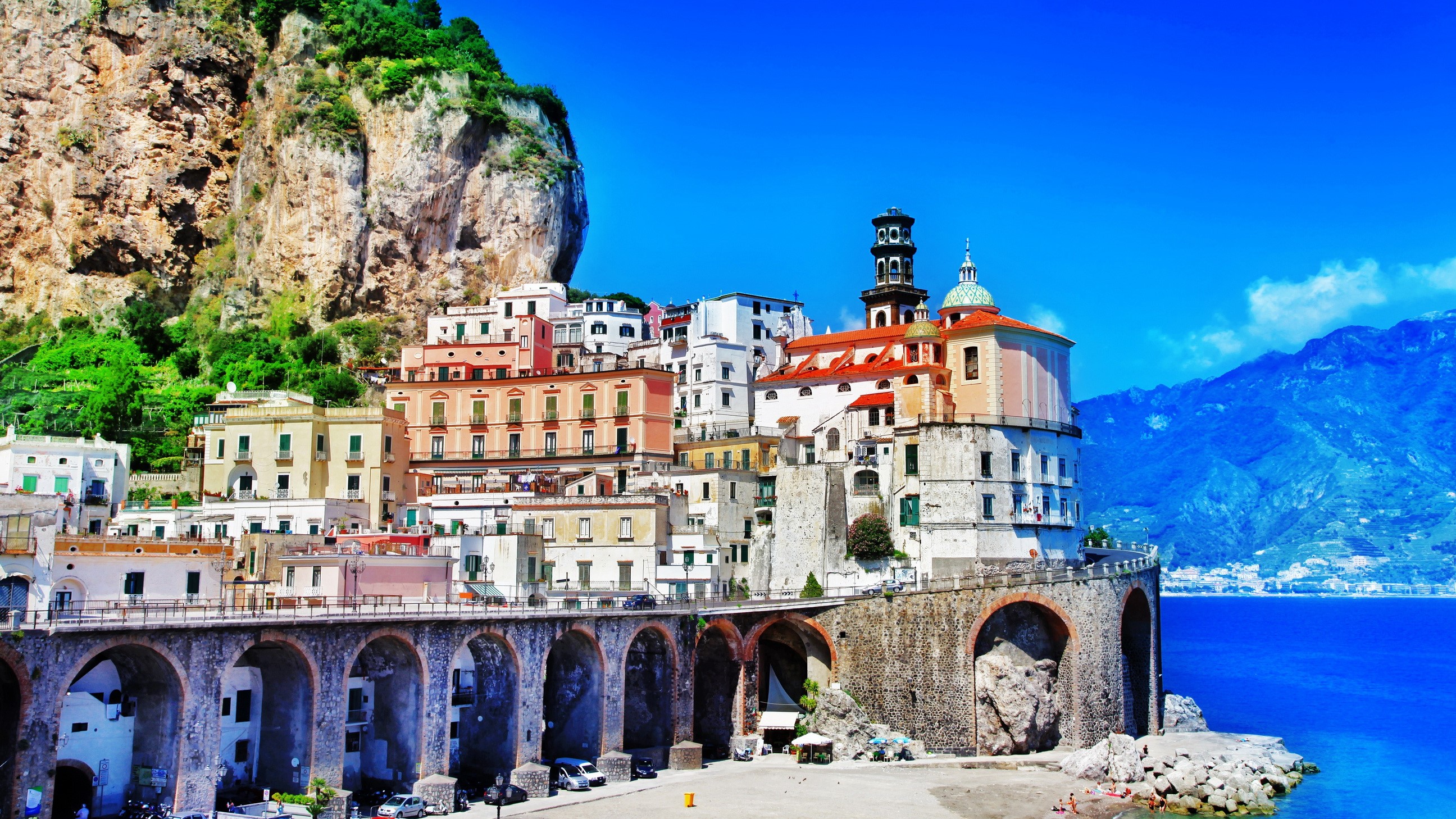 Amalfi Coast town with colorful houses and arched bridge HD Wallpaper