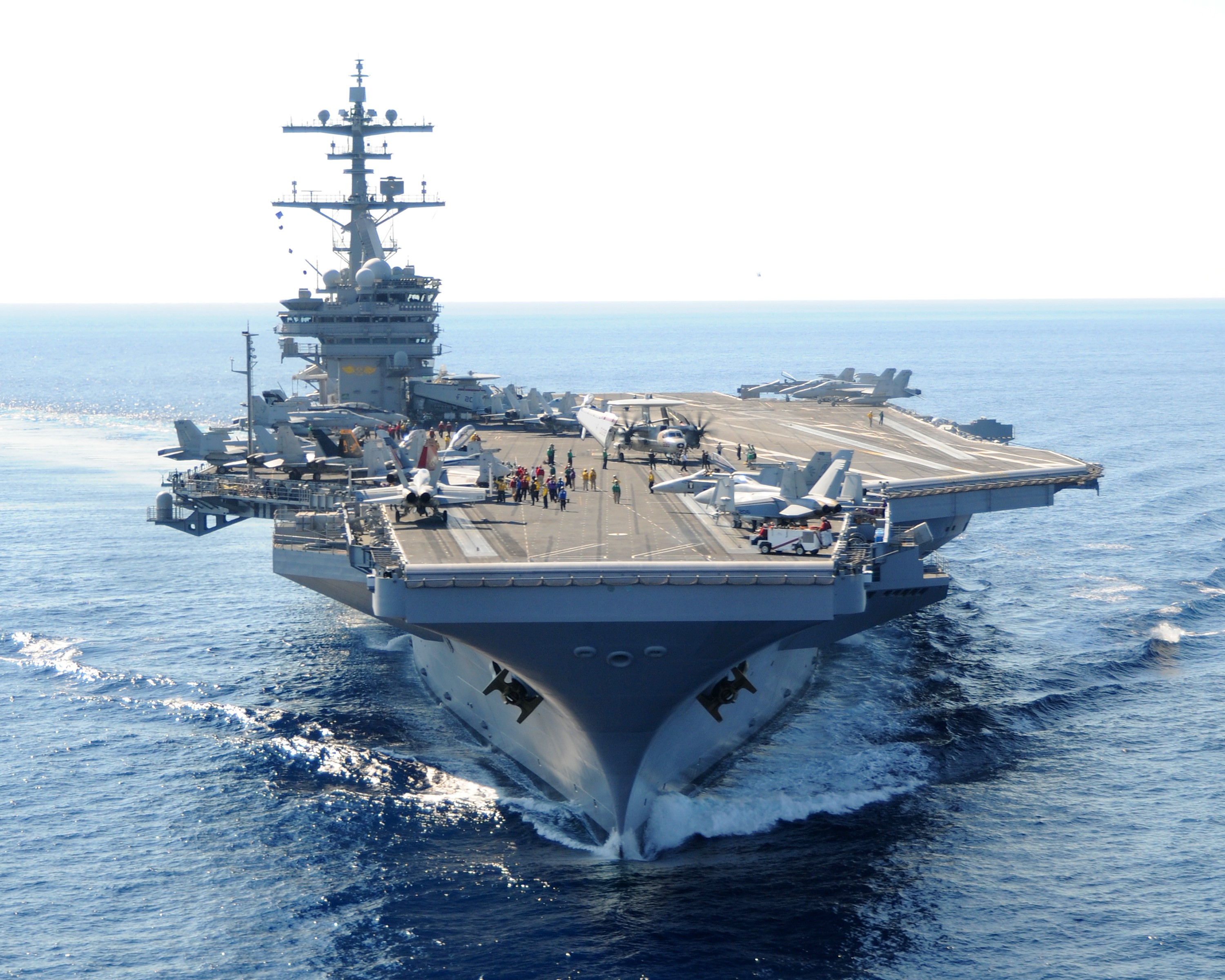 Aircraft carrier sailing on the ocean with airplanes HD Wallpaper