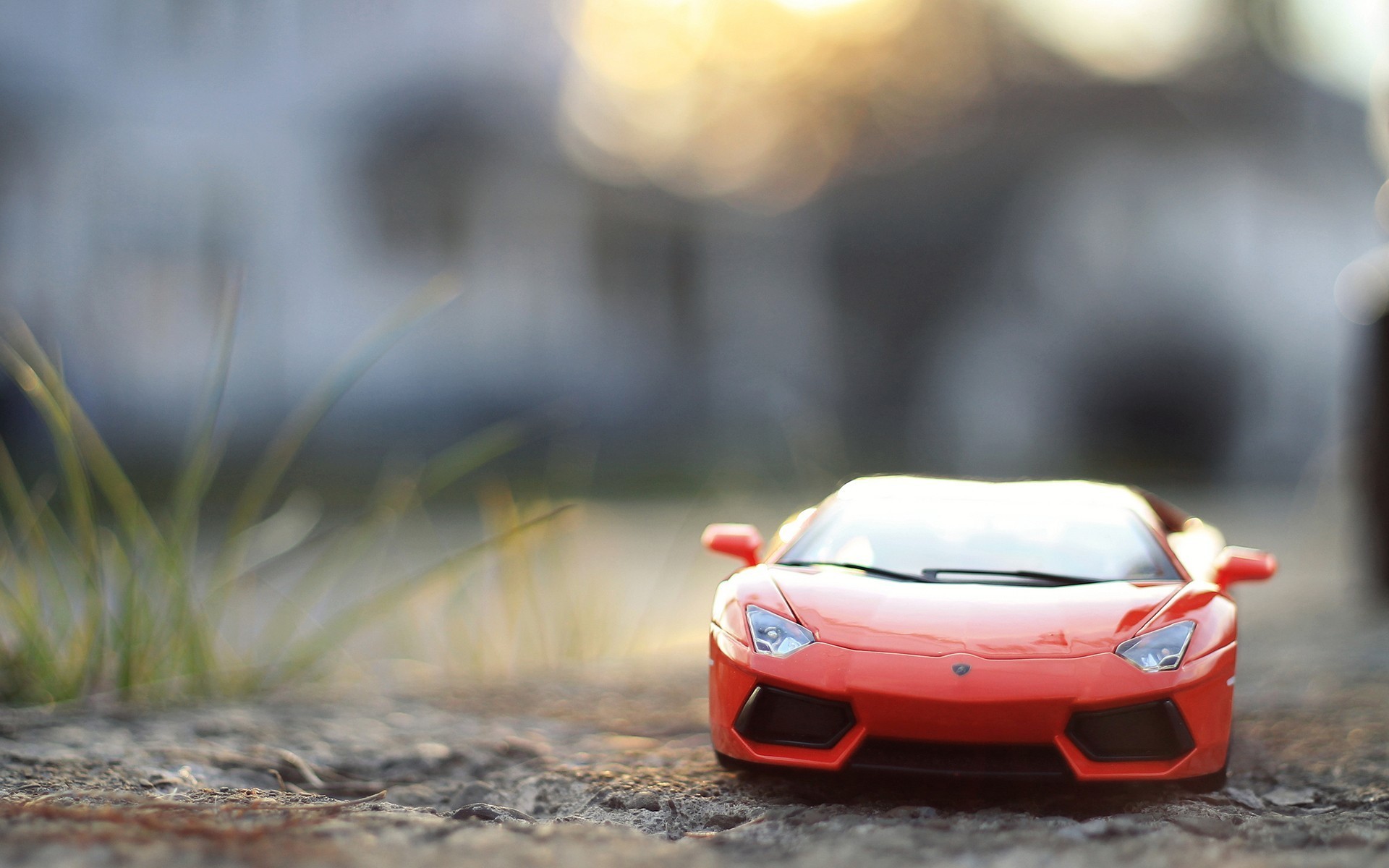 Orange toy sports car on the ground HD Wallpaper
