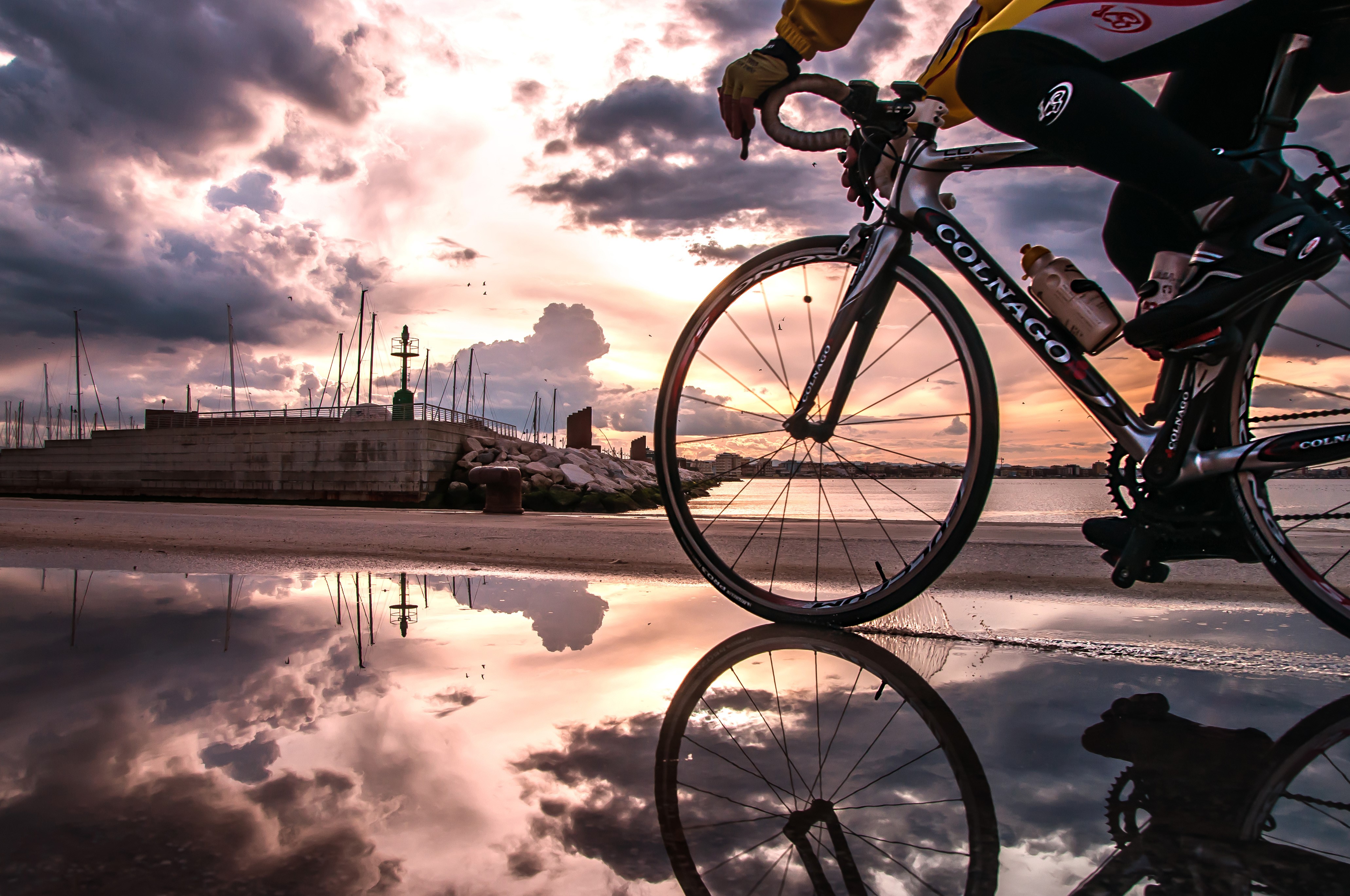 Cyclist on Colnago Bicycle by Water at Sunset HD Wallpaper