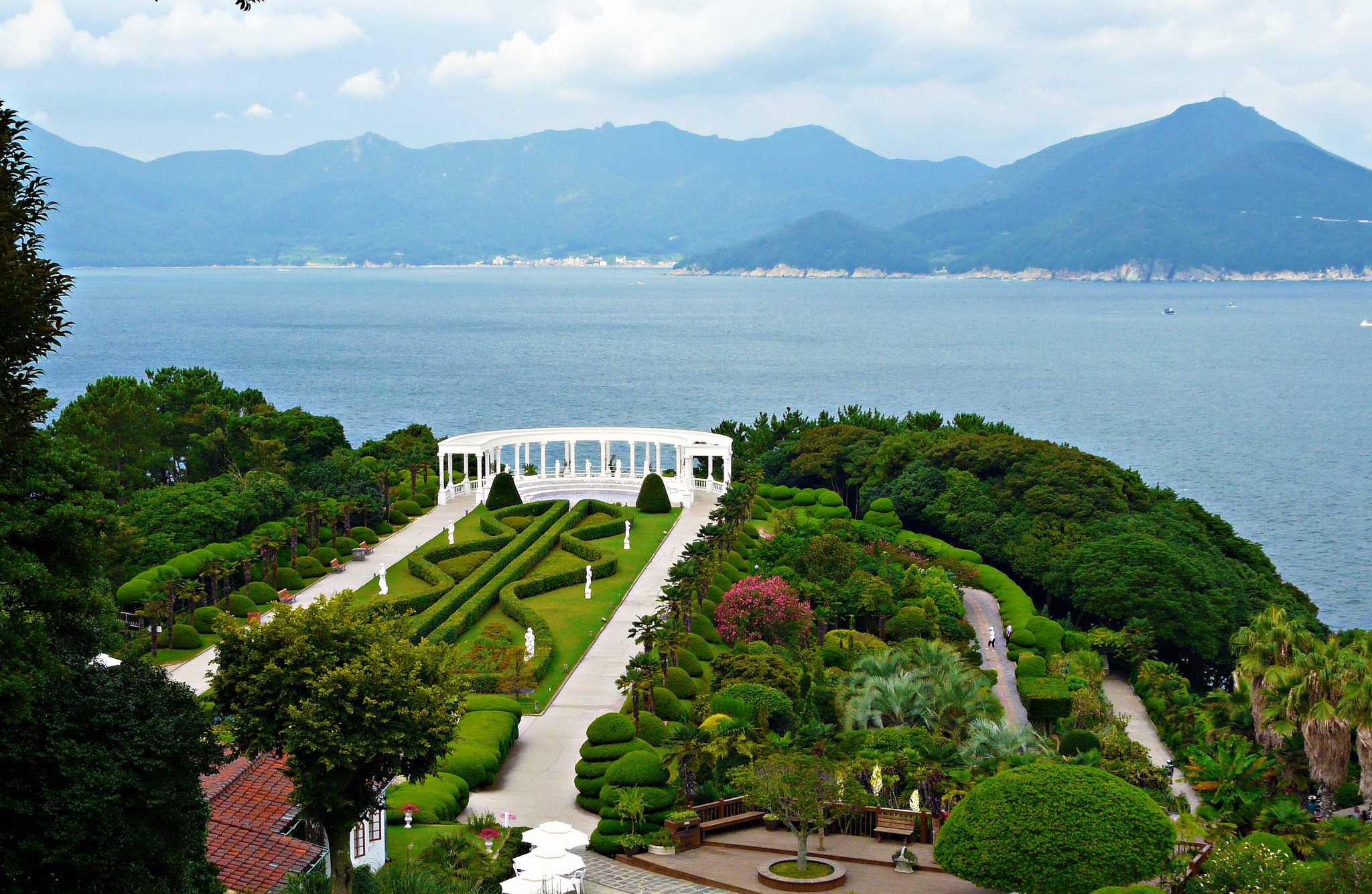 Garden with a white gazebo overlooking the sea and mountains HD Wallpaper